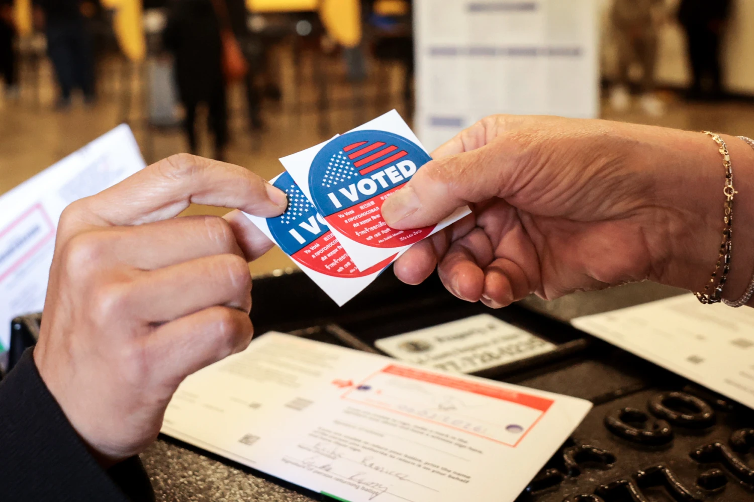 Voters hold "I Voted" stickers at the polls during Tuesday's primary election, on June 2, 2026.