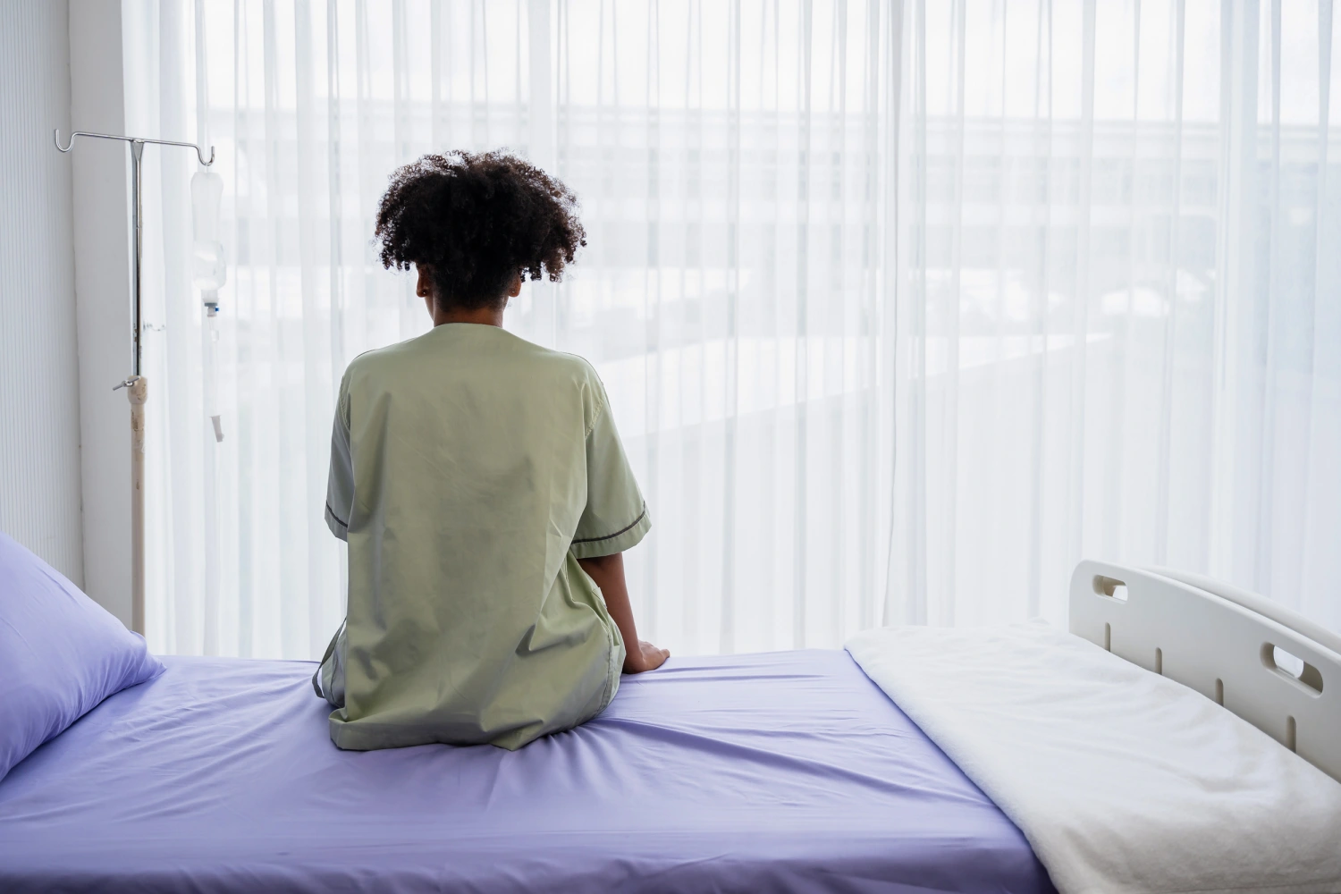 Patient sitting on the hospital bed.