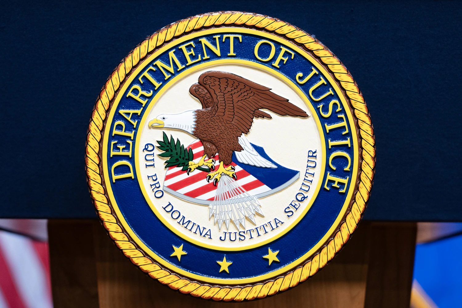 The seal of the Department of Justice is seen before Acting Attorney General Todd Blanche conducted a news conference at the Department of Justice about the Trump Administration's anti-fraud efforts on Tuesday, April 7, 2026. 