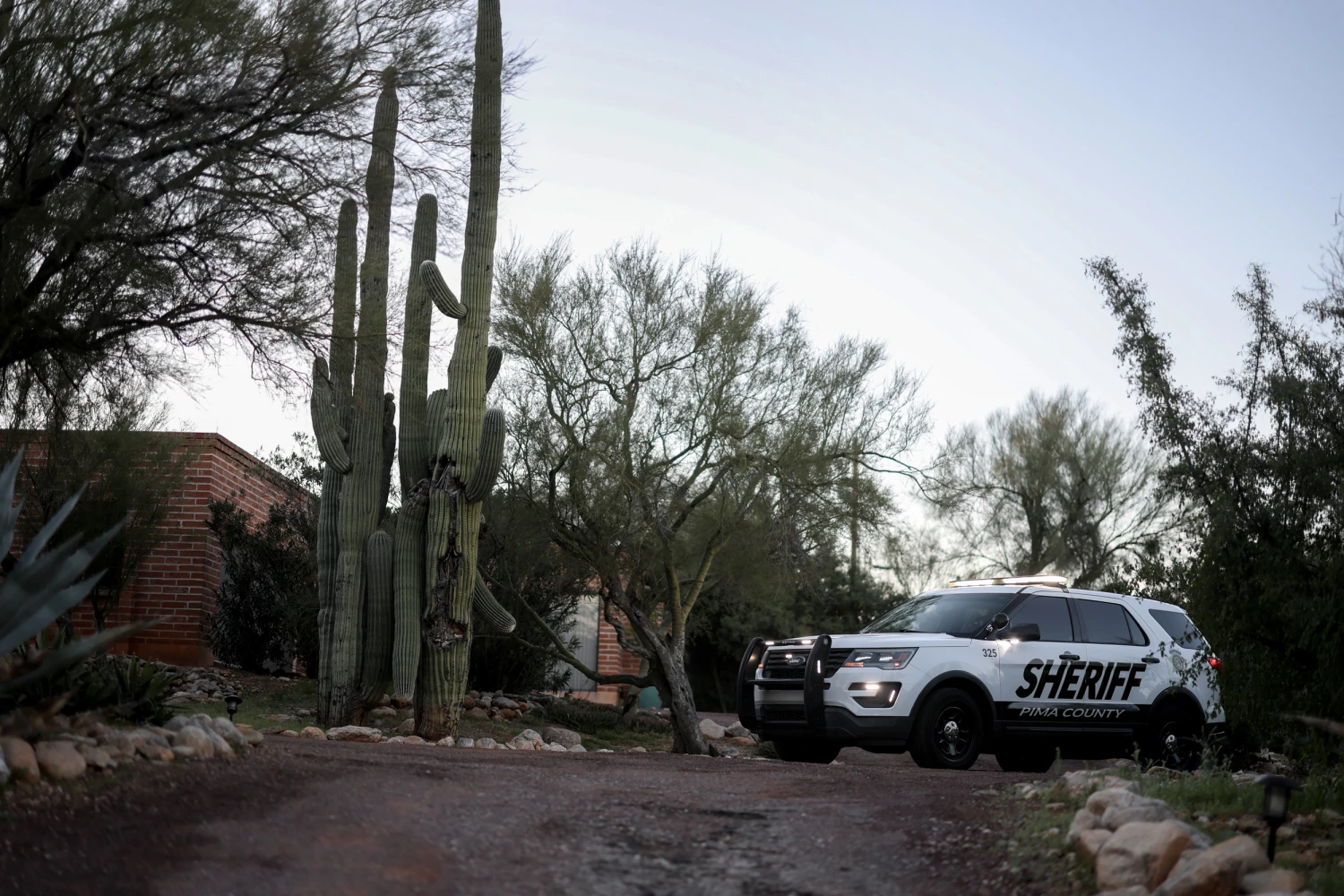 A Pima County Sheriff's vehicle parks in the driveway of the home of Nancy Guthrie on February 21, 2026, in Tucson, Ariz.