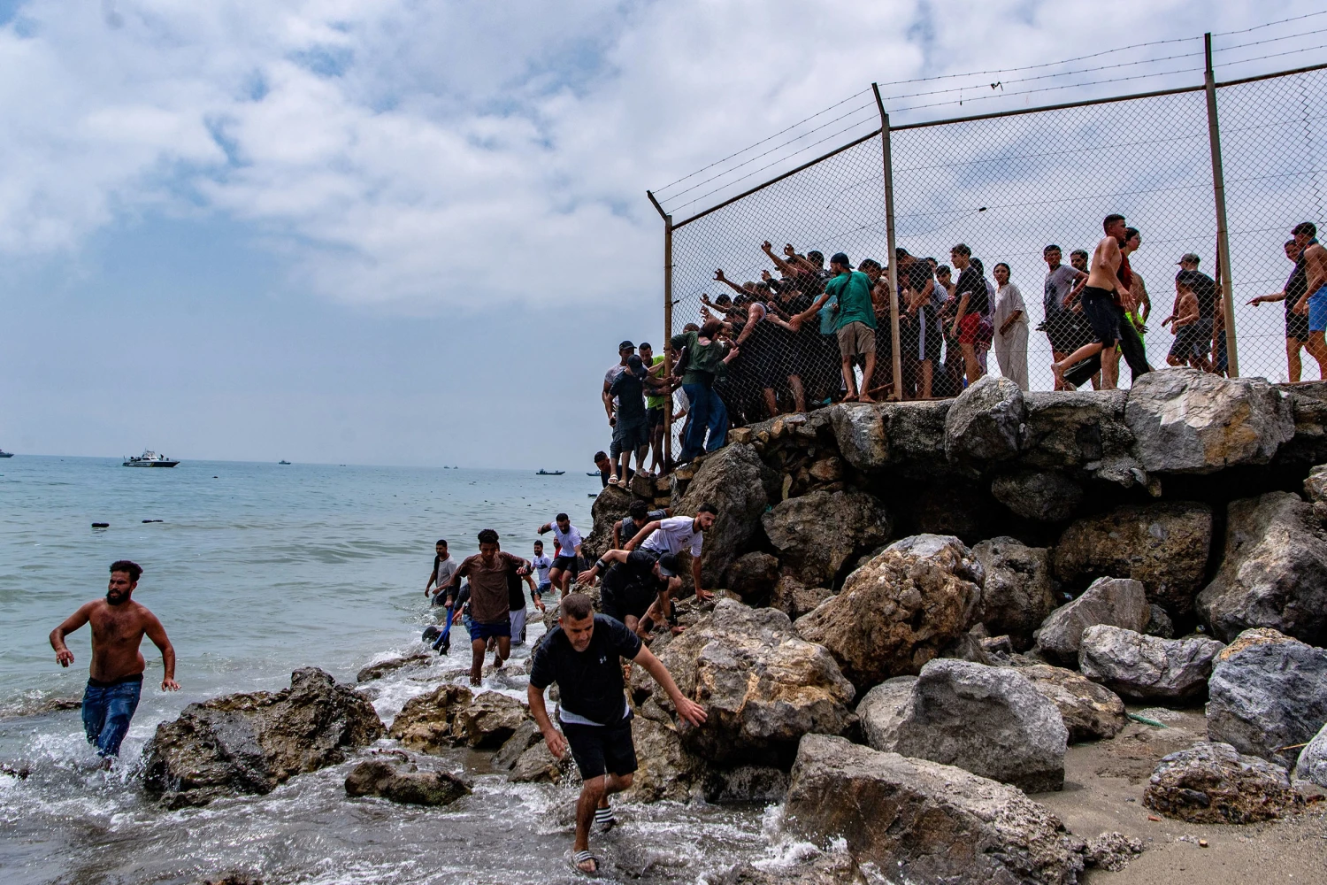 Migrants cross from Morocco into the Spanish enclave of Ceuta, Thursday, July 30, 2026.