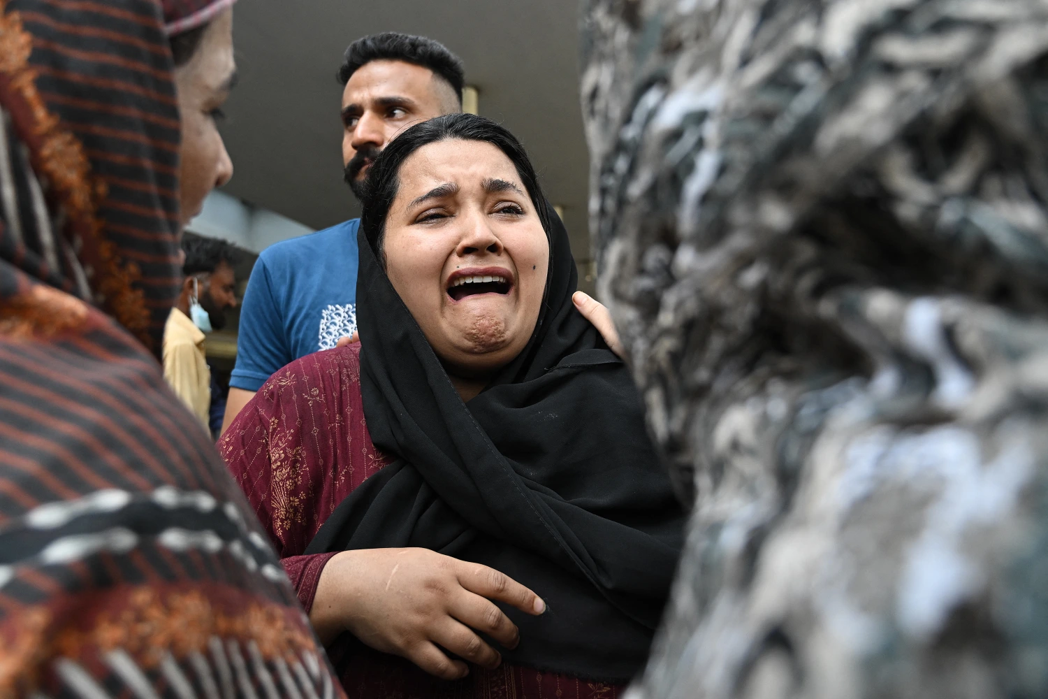 A mother reacts after the death of her child following a fire incident outside the Mother and Child Health (MCH) ward at the Pakistan Institute of Medical Sciences (PIMS) Hospital in Islamabad on August 26, 2026. A fire at a hospital in the Pakistani capital Islamabad on August 26 morning killed 14 children, a local authority said. (Photo by Aamir QURESHI / AFP via Getty Images)