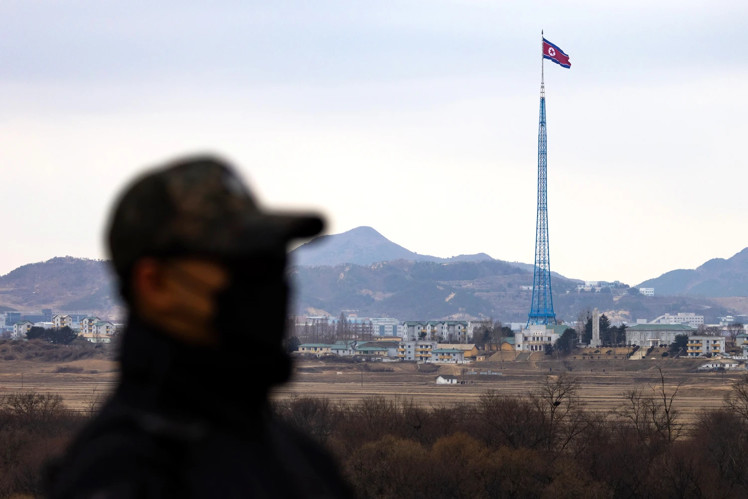 A North Korean flag flies above North Korea's Gijungdong village, from the truce village of Panmunjom in the Demilitarized Zone (DMZ) in Paju, South Korea, on Friday, March 3, 2023.