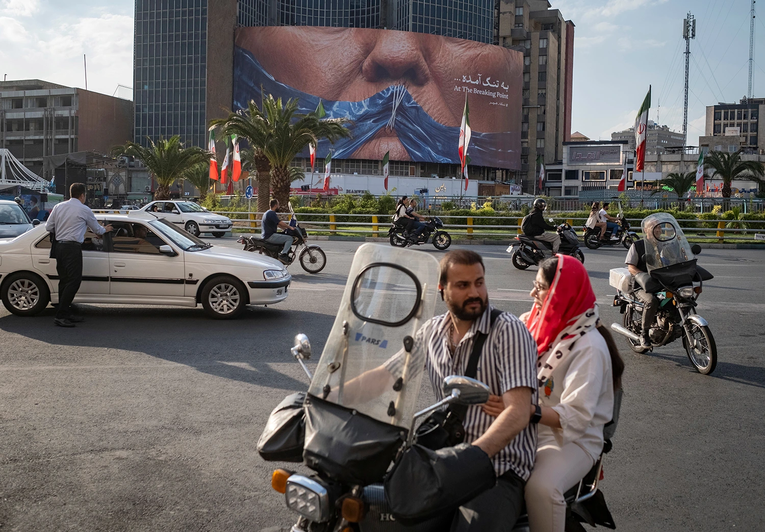 An AI-generated billboard displayed in Tehran in May depicts the Strait of Hormuz sewn across the lips of President Trump.