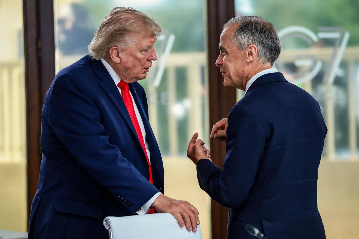 President Donald Trump speaks with Canadian Prime Minister Mark Carney at a working lunch with leaders of G7 and the Middle East, on June 16, 2026 in Evian-les-Bains, France.