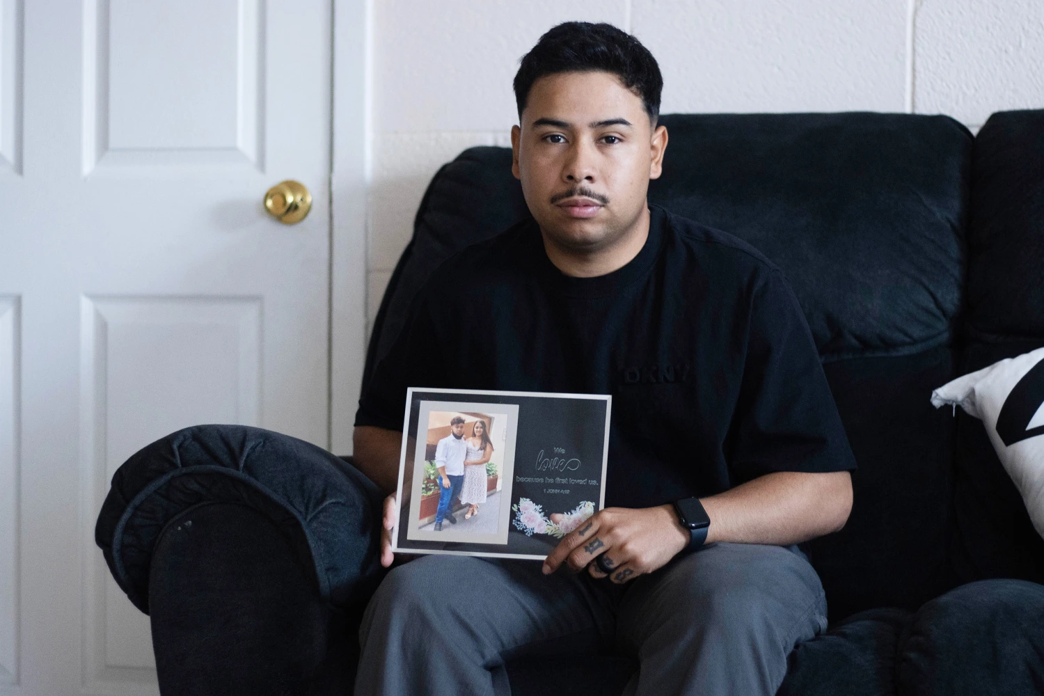 Army Sgt. Hedar Leonel Turcios Juarez holds a picture of himself with with his wife Cristy at home in El Paso, Texas, July 21, 2026. 