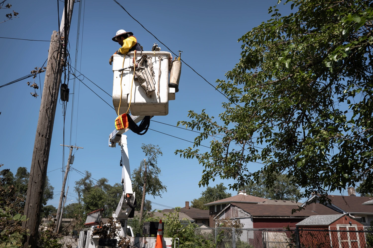 Workers repair an electrical line damaged during a recent storm in Gary, Ind., on Thursday.