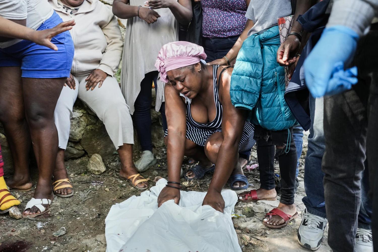 People mourn over the bodies of people they said were their relatives and killed in a gang attack in the Kenscoff neighborhood of Port-au-Prince, Haiti, on Aug. 24, 2026.