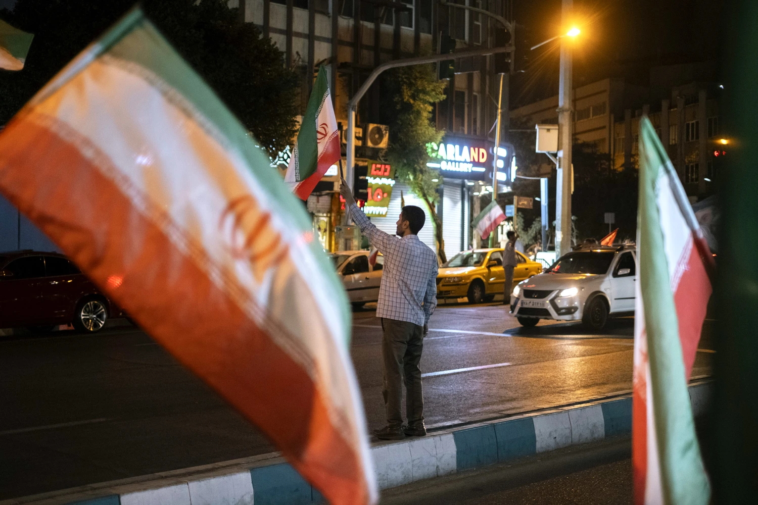 Pro-government supporters wave Iranian national flags during a nightly rally in downtown Tehran, Iran, on August 23, 2026, following the expiration of a 60-day ceasefire between Iran and the United States on August 17, 2026, with no new agreement reached between the two sides.