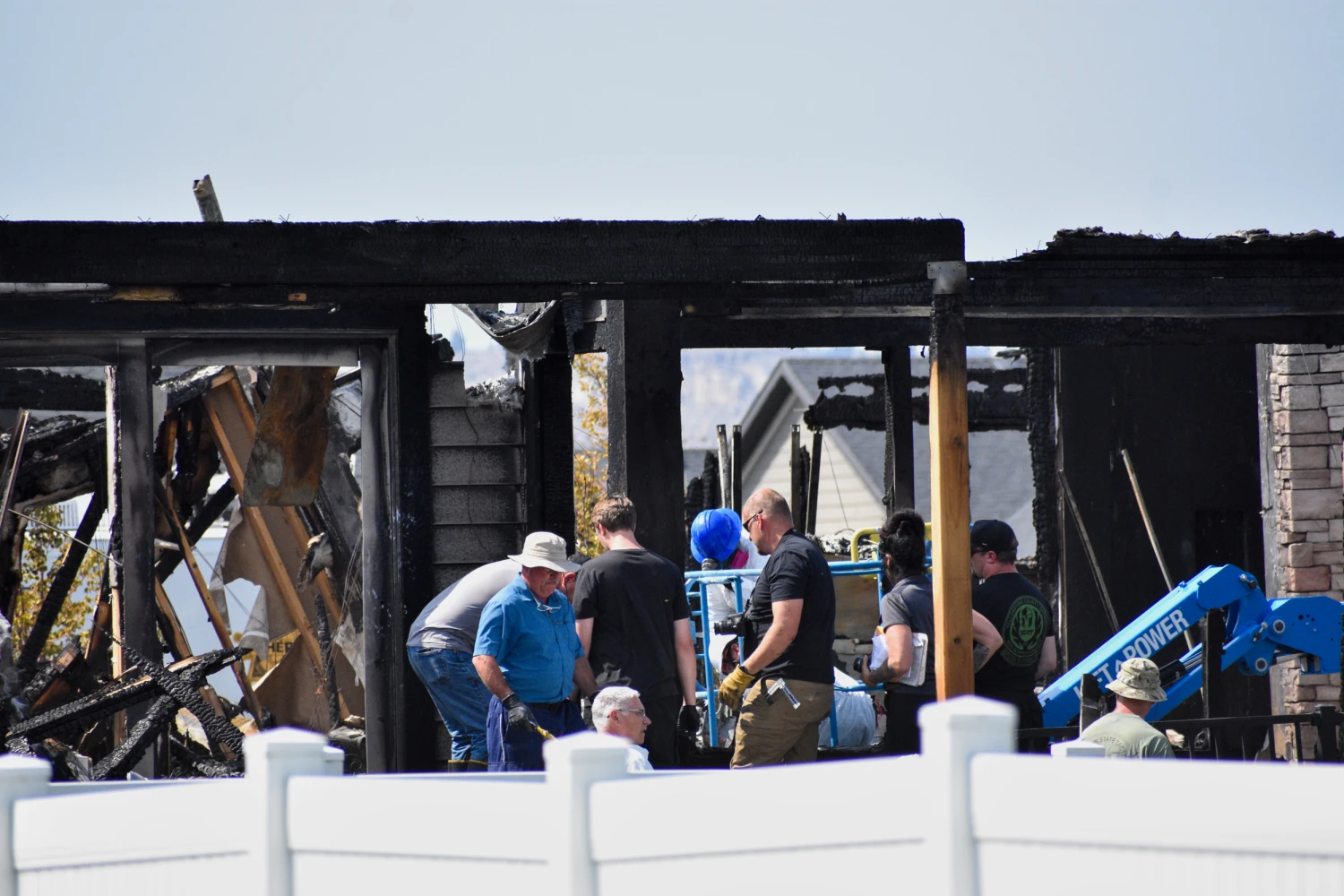 Investigators work at the scene where a family was killed and the house burned in Billings, Mont., on Aug. 25, 2026.