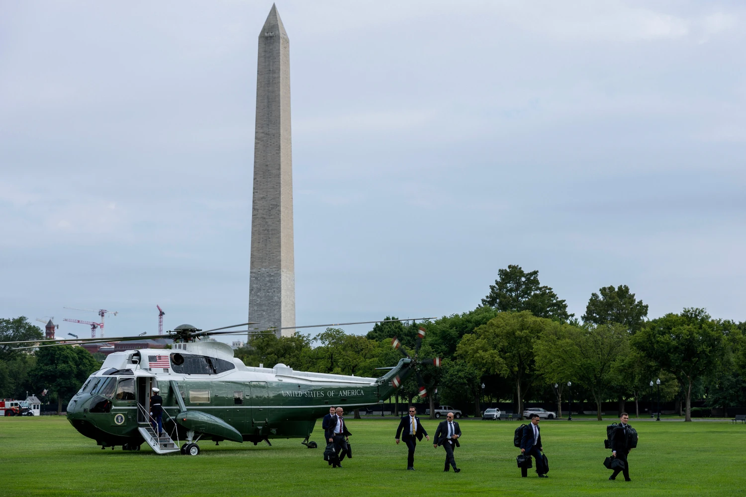 United States Secret Service agents land before Marine One with U.S. President Donald Trump aboard at the Ellipse near the White House on Aug., 13, 2026 in Washington, DC.