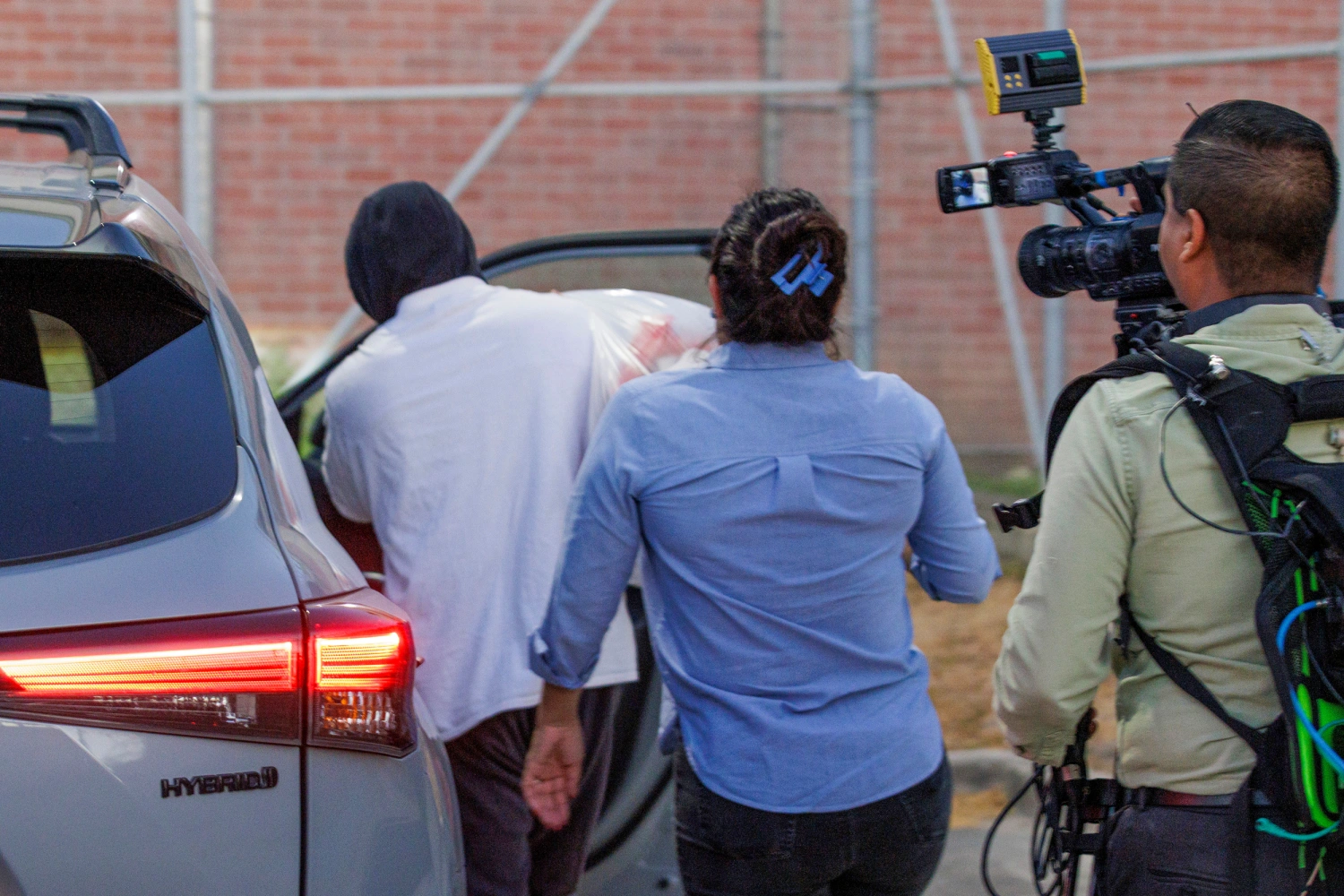 ICE officer Christian Castro gets into a car surrounded by news reporters moments after being released from the Carrizalez-Rucker Cameron County Detention Center in Brownsville, Texas, on Aug. 27, 2026.