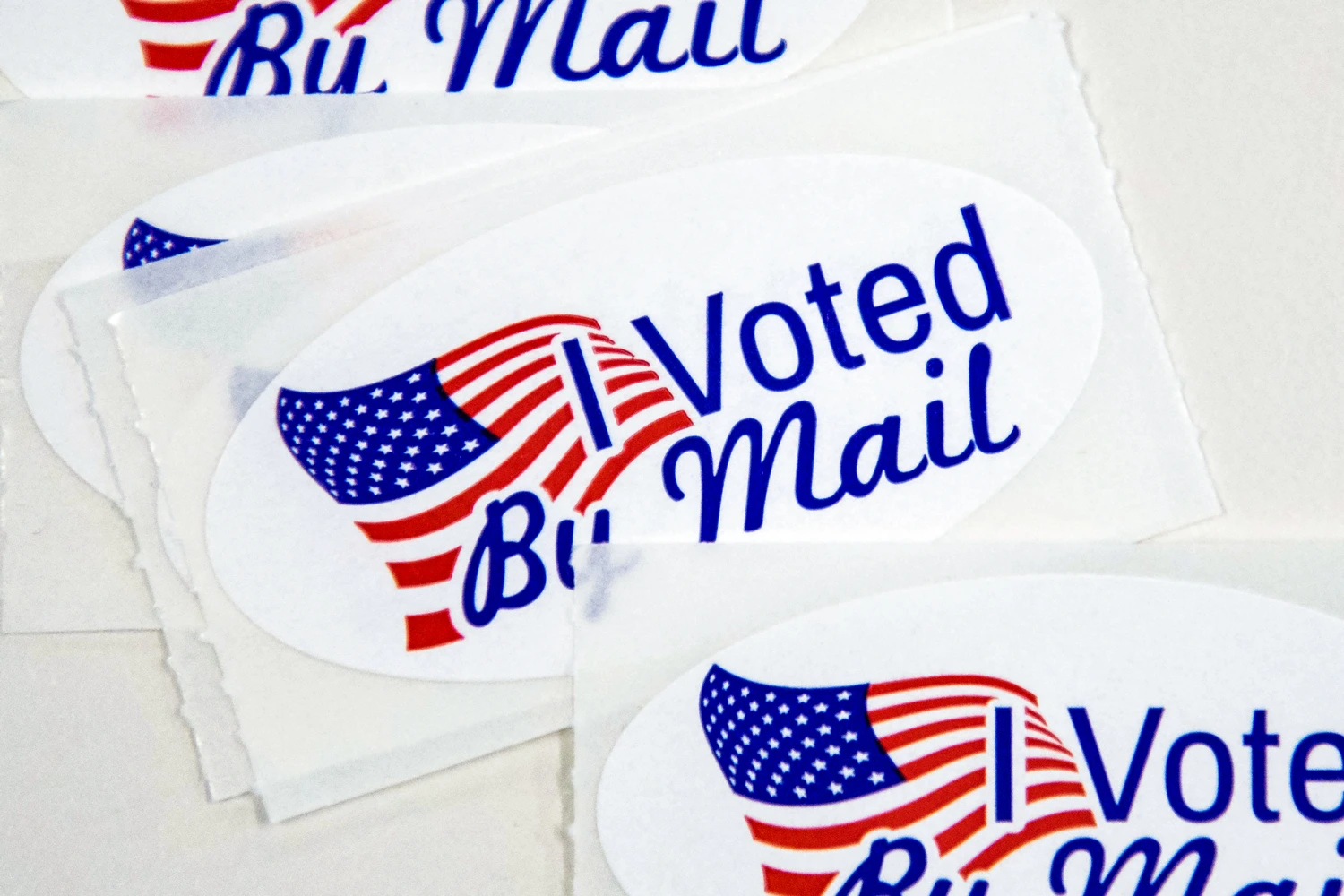 Stickers that read "I Voted By Mail" sit on a table waiting to be stuffed into envelopes by absentee ballot election workers at the Mecklenburg County Board of Elections office in Charlotte, N.C., on Sept. 4, 2020.