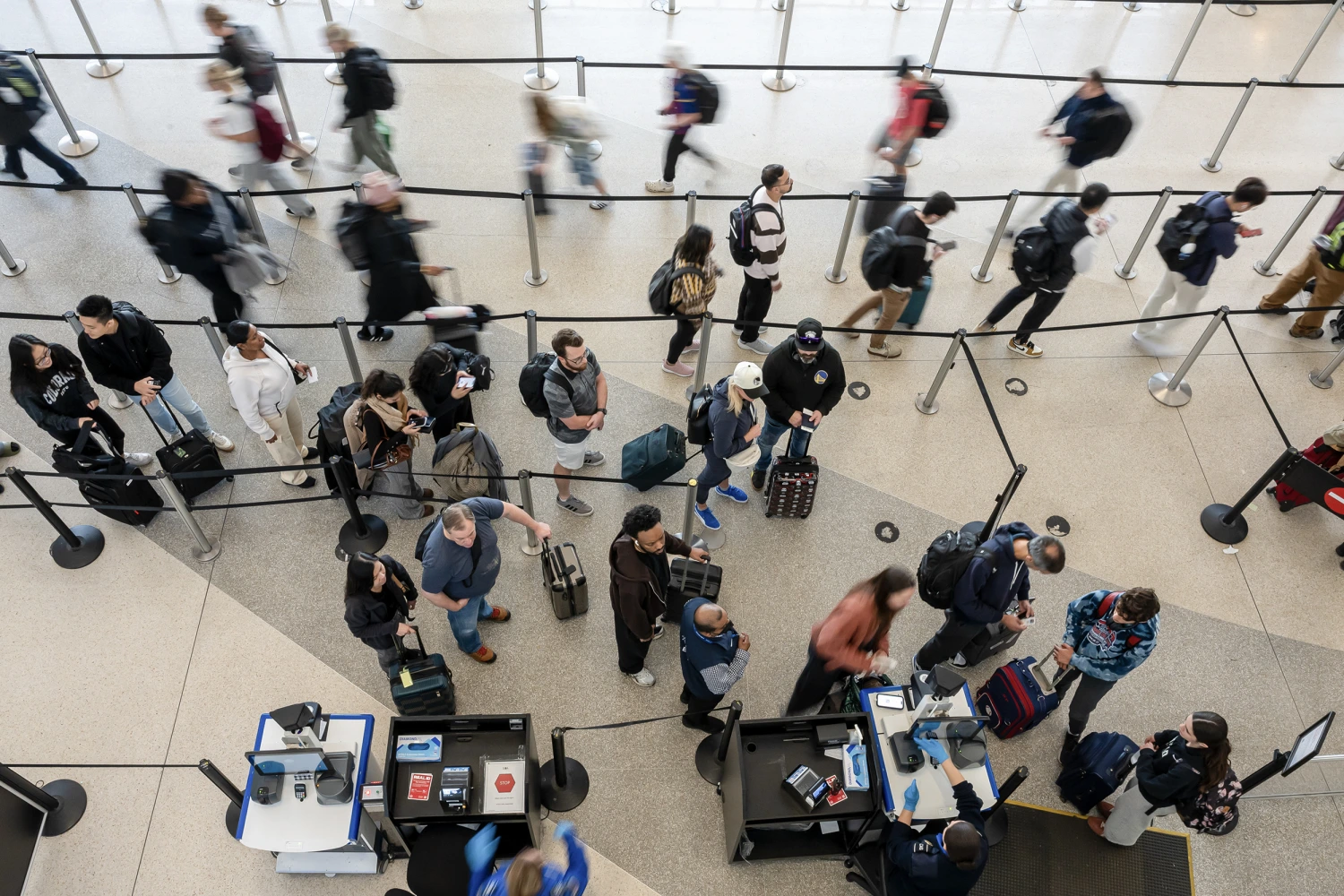 Travelers wait in line at a Transportation Security Administration (TSA) checkpoint at San Francisco International Airport (SFO) in San Francisco, California, US, on Tuesday, Nov. 25, 2025.
