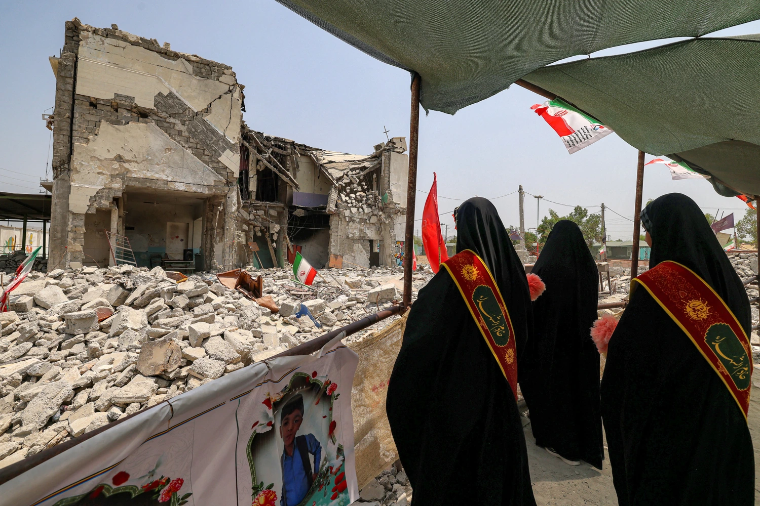 Women stand near the building of the destroyed Shajareh Tayyebeh primary school in Minab in Iran's Hormozgan province on August 10, 2026.