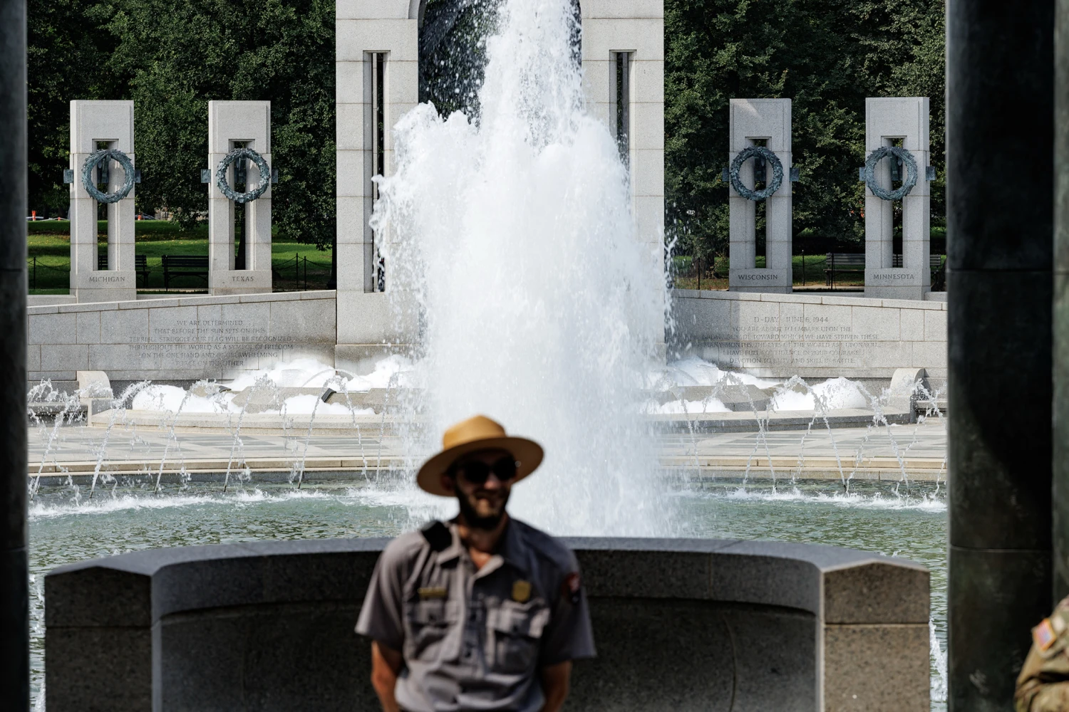 Vandalism can be seen at the World War II Memorial on August 13, 2026 in Washington D.C. Spray paint on the walls of the memorial states, "Clean hands Dirty $", and soap bubble over in the fountain below the graffiti.