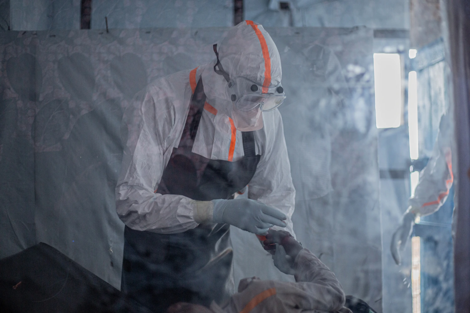 A doctor provides care to a patient with Ebola virus disease at the Rwampara Ebola Treatment Centre (ETC) in Bunia, Ituri, in the east of the Democratic Republic of Congo on July 13, 2026.