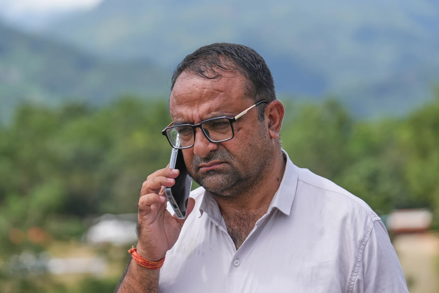 Rajendra Dawadi, a school teacher of Tribhuvan Trishuli Secondary School, talks on his mobile phone in Trishuli Valley in Nepal's Nuwakot district, Monday, Aug. 31, 2026.