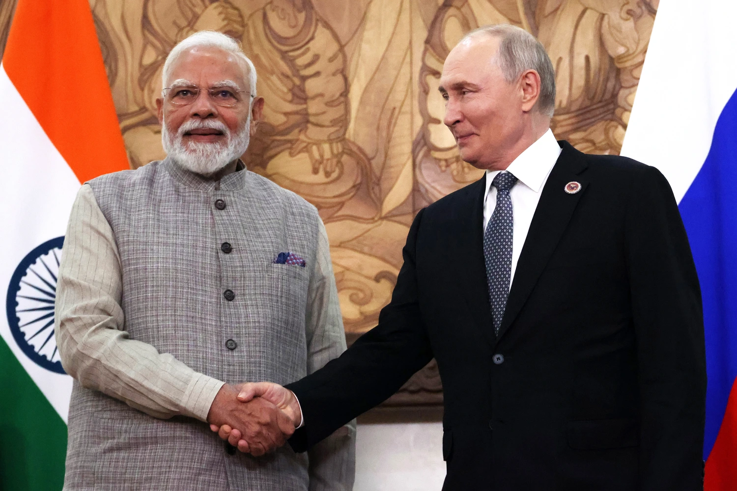 Russian President Vladimir Putin (C) shakes hands with Indian Prime Minister Narendra Modi (L) during the Shanghai Cooperation Organization Summit on August 31, 2026 in Bishkek, Kyrgyzstan.