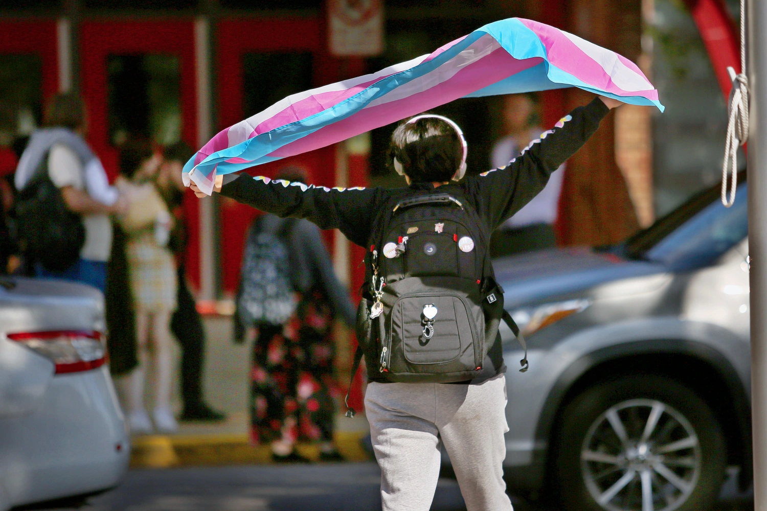 A Bayside High School student protests the governor's new transgender policies in front of the school on Feb. 13, 2024, in Virginia Beach, Va.