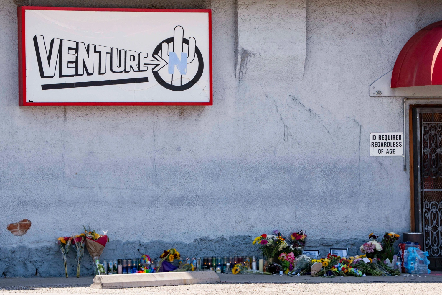 A growing memorial sits outside the Venture-N Bar in Tucson, Ariz., Tuesday, Sept. 1, 2026, for Vincent Siquieros and Cameron Capara, who were fatally shot in the parking lot of the gay bar shortly after midnight Monday.