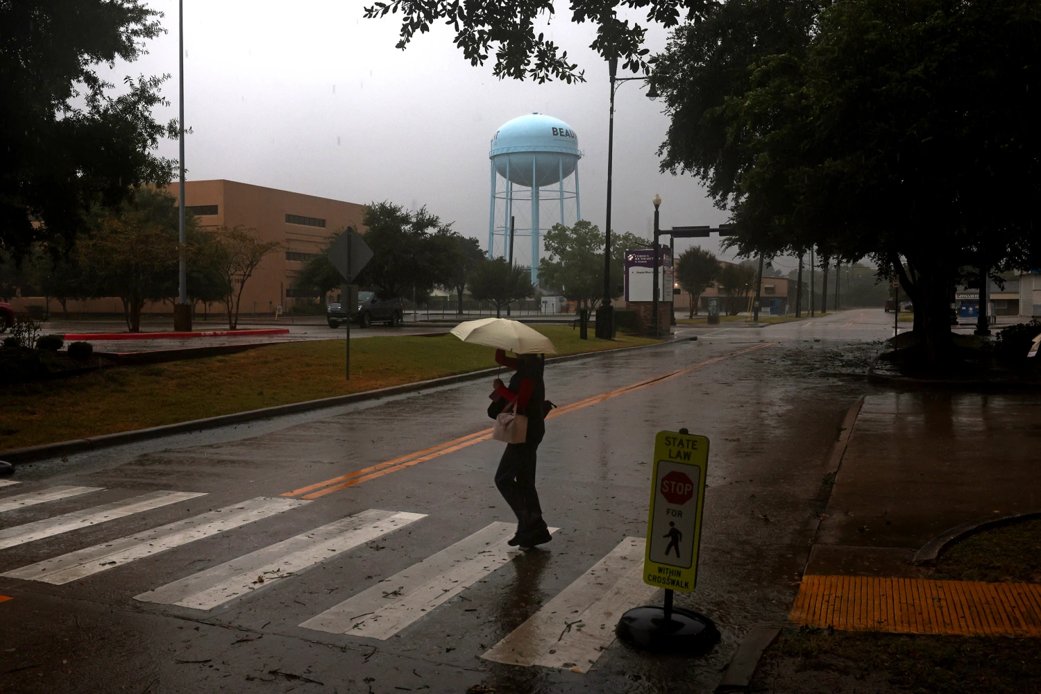 A medical worker heads to work during Tropical Storm Edouard on Tuesday, in Beaumont, Texas.