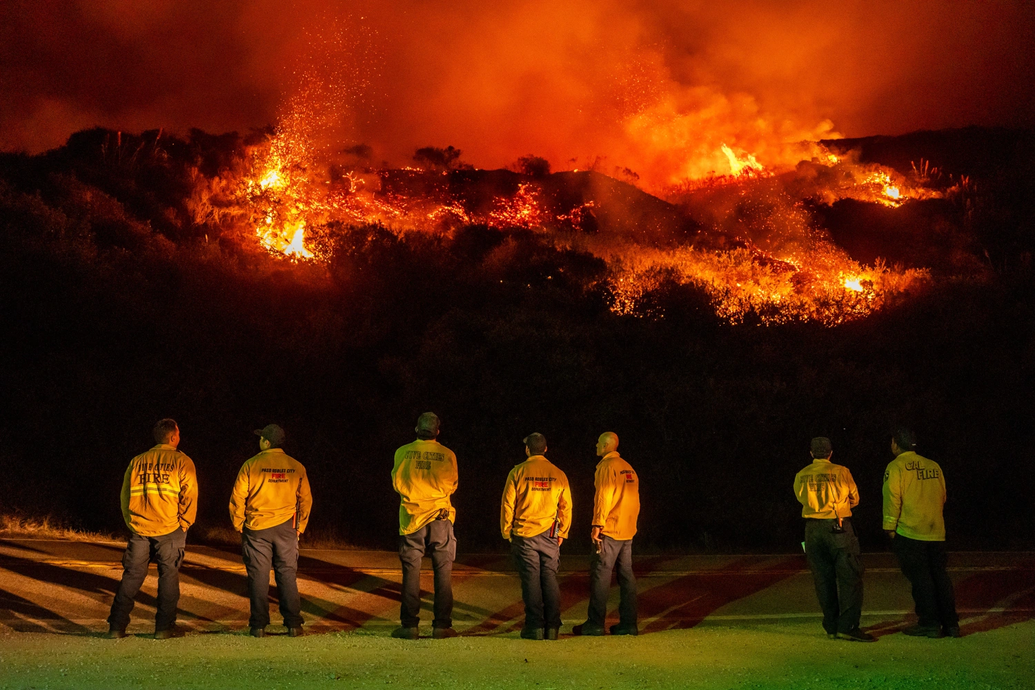 Firefighters watch as a wildfire called the Plaskett Fire burns towards Highway 1 on Friday, Aug. 28, 2026, in Big Sur, Calif.