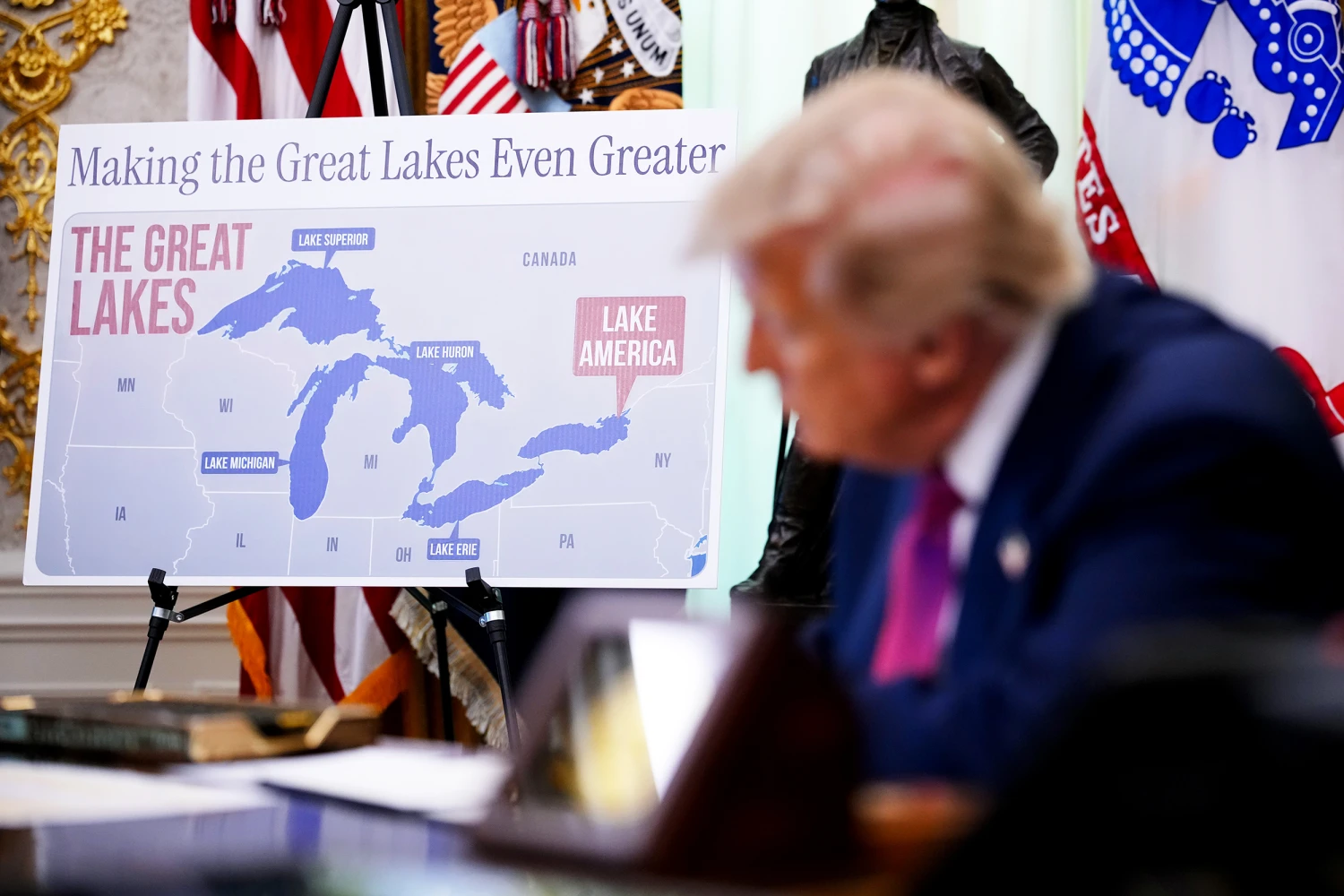 A map labeling Lake Ontario as "Lake America" is displayed as U.S. President Donald Trump signs an executive order during an event in the Oval Office of the White House on August 27, 2026 in Washington, DC.