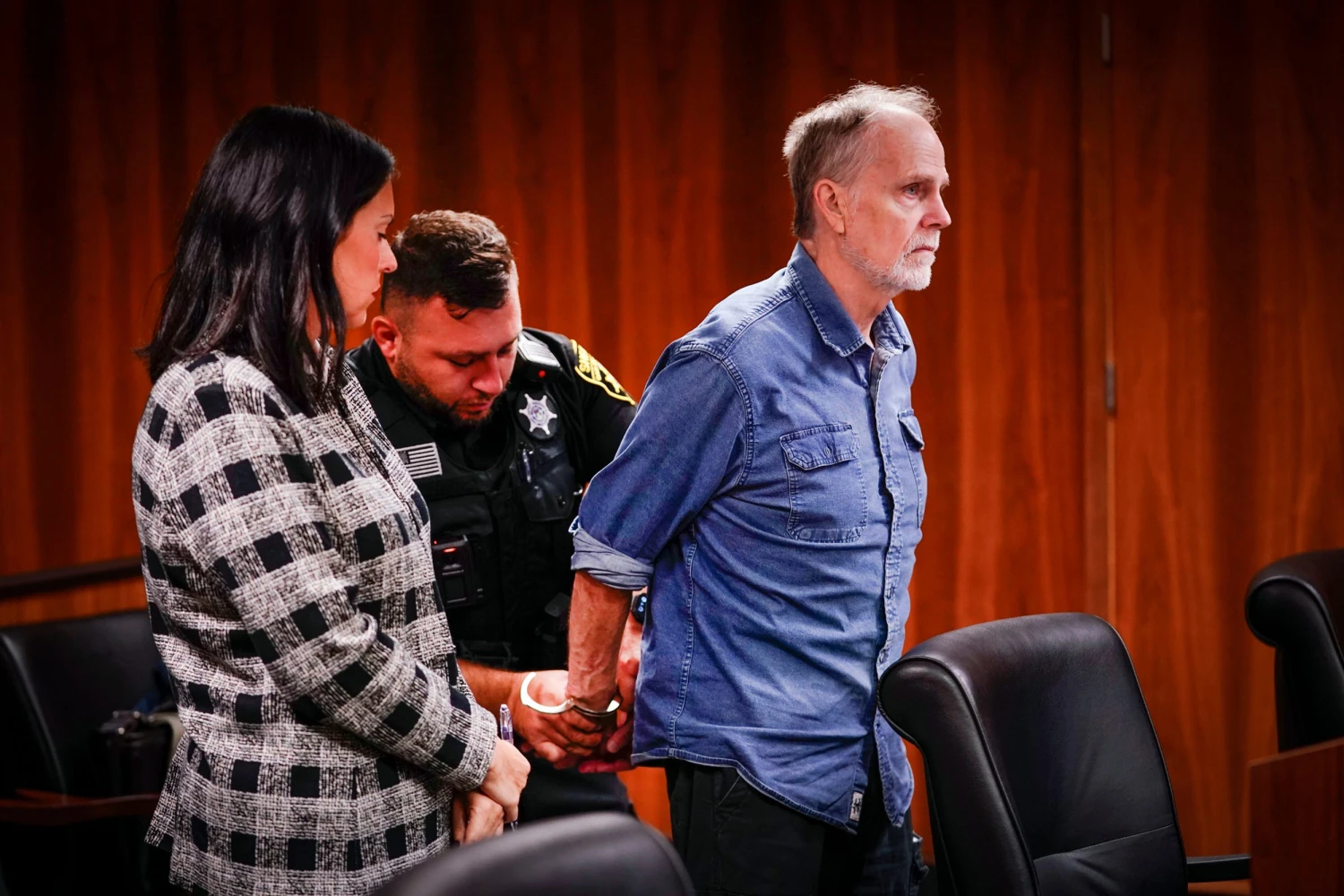 Defense attorney Alona Sharon stands at left as her client, Jeffrey Mosteller, is handcuffed. Mosteller is sentenced to 19 months to 15 years in prison as part of a plea agreement with state Attorney General Dana Nessel in the Oakland County Circuit courtroom of Judge Kwame Rowe on Monday, Aug. 31, 2026.