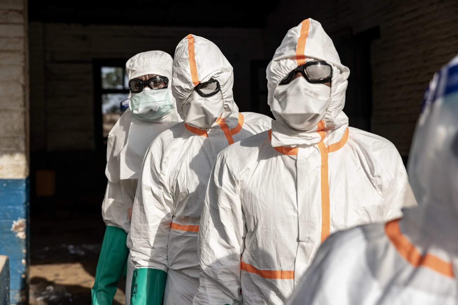 Workers line up to disinfect their protective equipment at General Referral Hospital of Mongbwalu during the Ebola outbreak response in Mongbwalu, Ituri province, eastern Democratic Republic of Congo, on May 20, 2026.