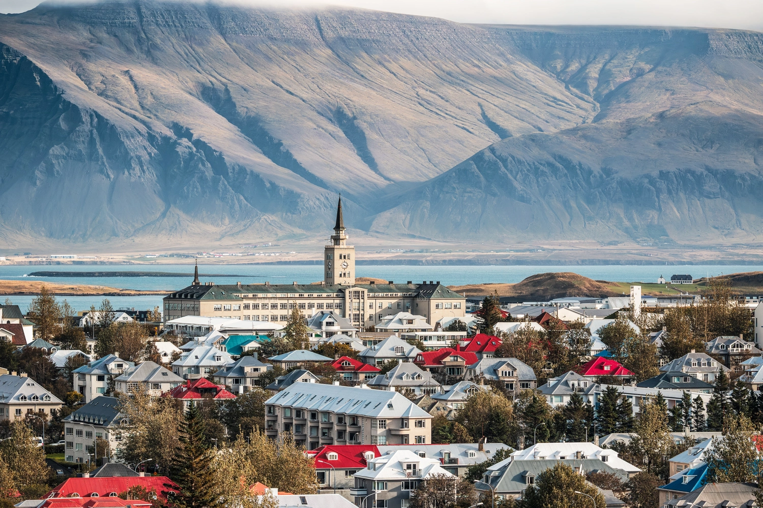 Cityscape of downtown Reykjavik in Iceland, featuring colourful houses, Tækniskólinn college and mountain Esjan in the background
