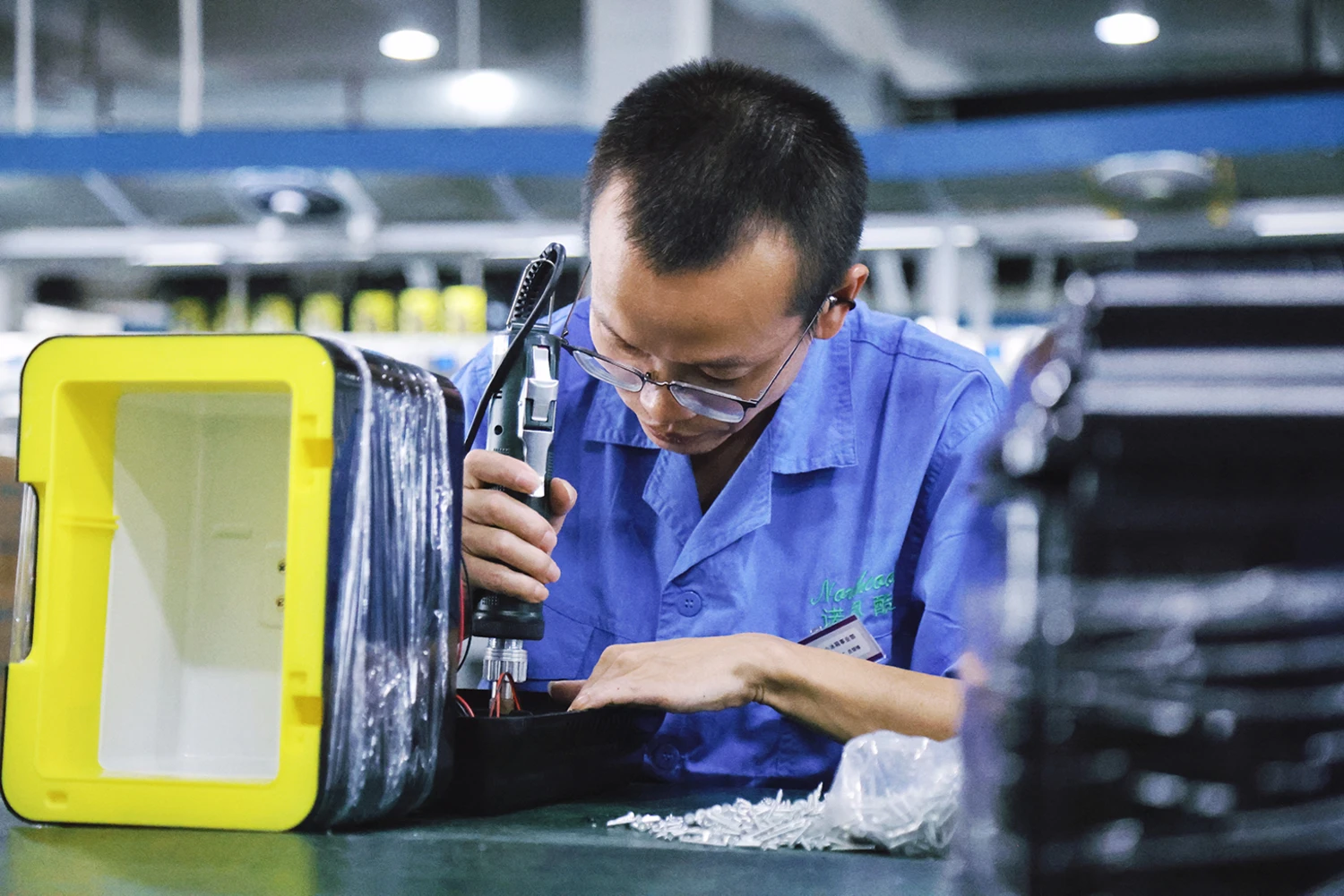 A worker assembles mini fridges for export in Shaoxing, China on Aug. 19, 2026.