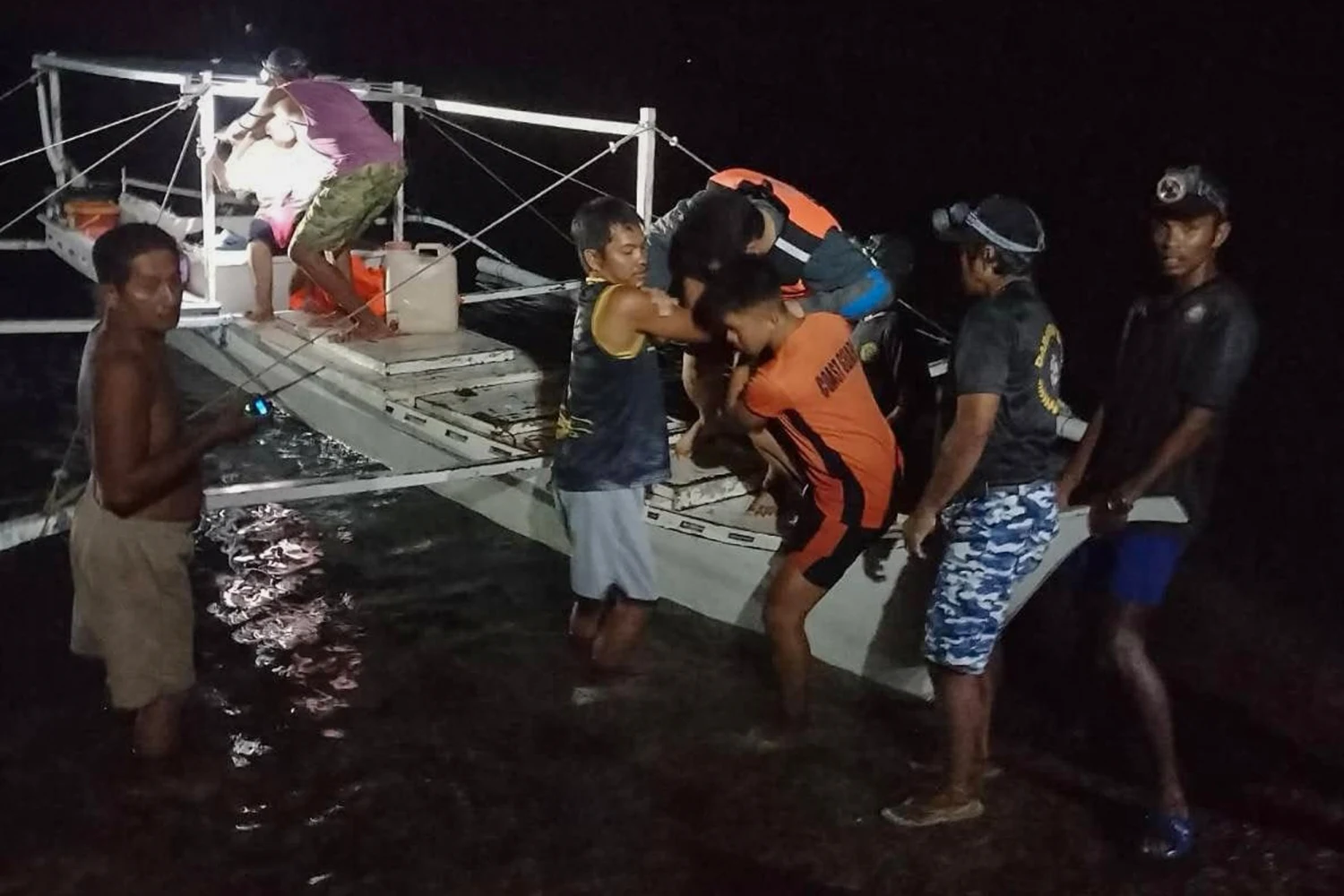 In this image provided by the Philippine Coast Guard, a survivor is assisted as he alights from a small boat after being rescued from a burning ferry off Palawan province, Philippines on Wednesday Sept. 9, 2026.