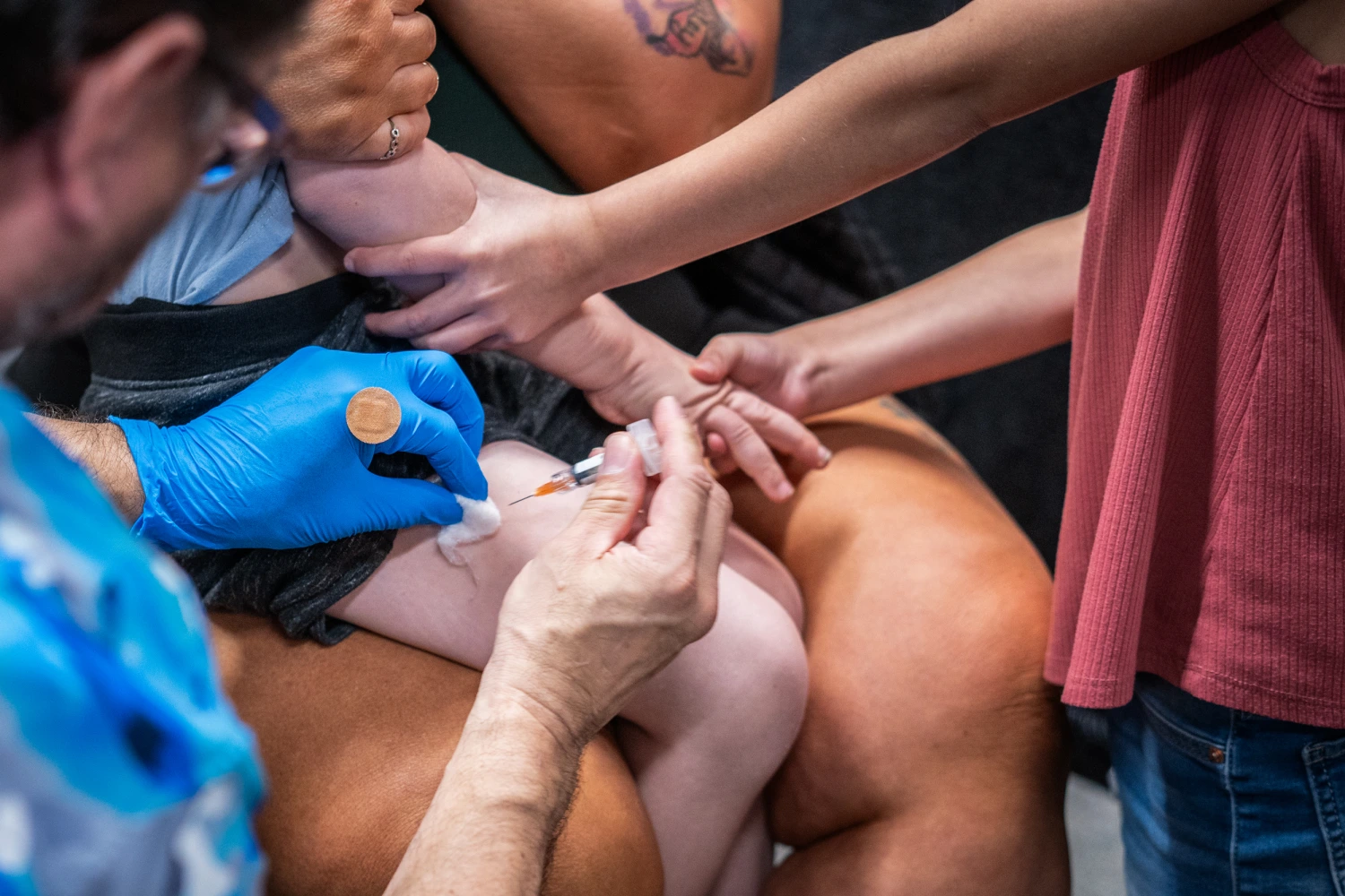 A family supports a young child as he recieives the MMR vaccine at a vaccine clinic put on by Lubbock Public Health Department on March 1, 2025 in Lubbock, Texas.