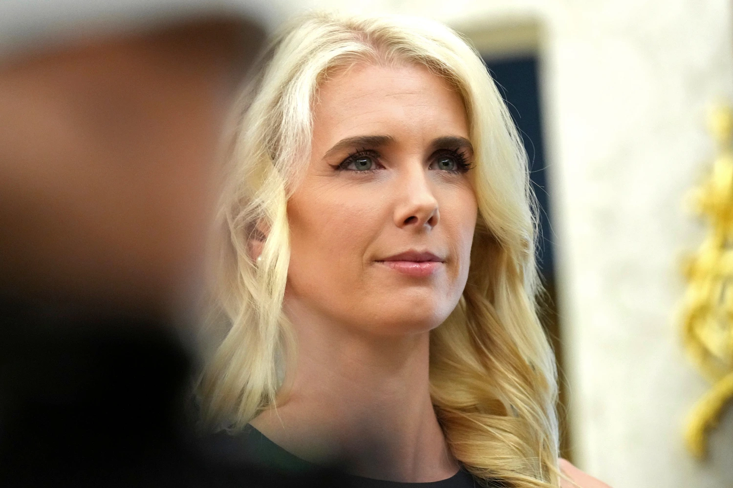 White House aide Natalie Harp listens as President Donald Trump speaks in the Oval Office of the White House, Monday, Aug. 31, 2026, in Washington.