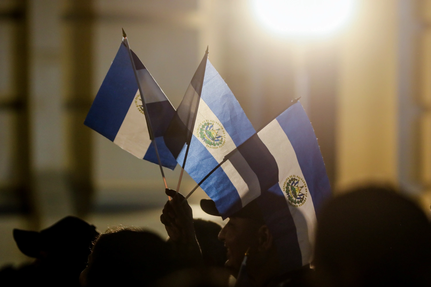 People raise El Salvador flags on June 1, 2025, in San Salvador, El Salvador.