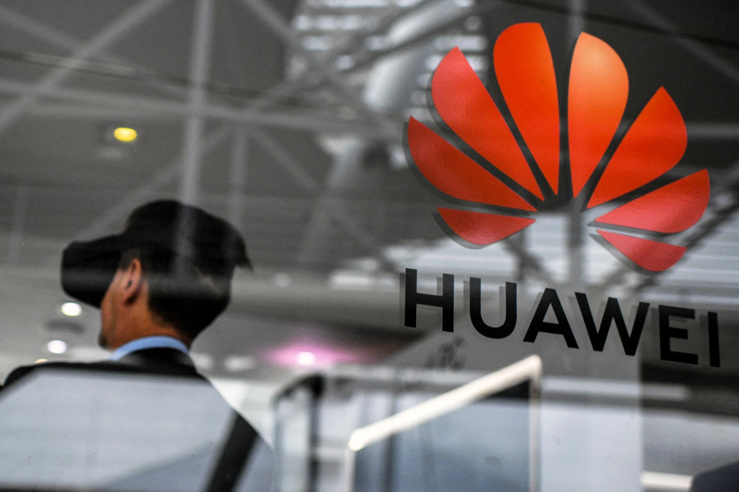 People visit the stand of Chinese telecom giant Huawei during the Web Summit in Lisbon on November 6, 2019.