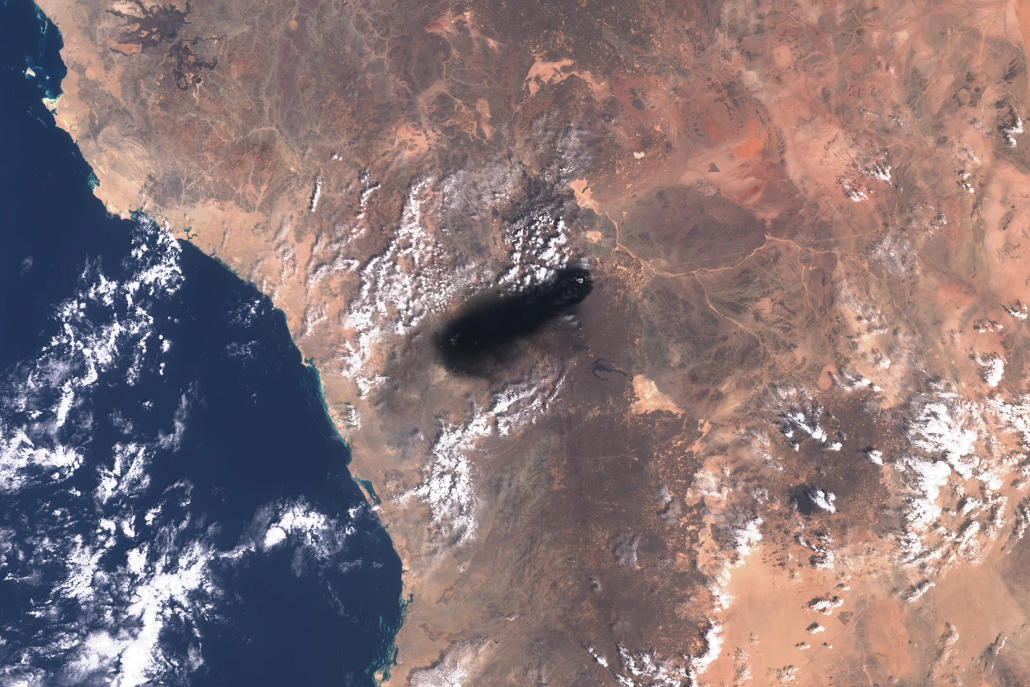 A 60-mile smoke plume along the route of the East-West oil pipeline, south of Medina