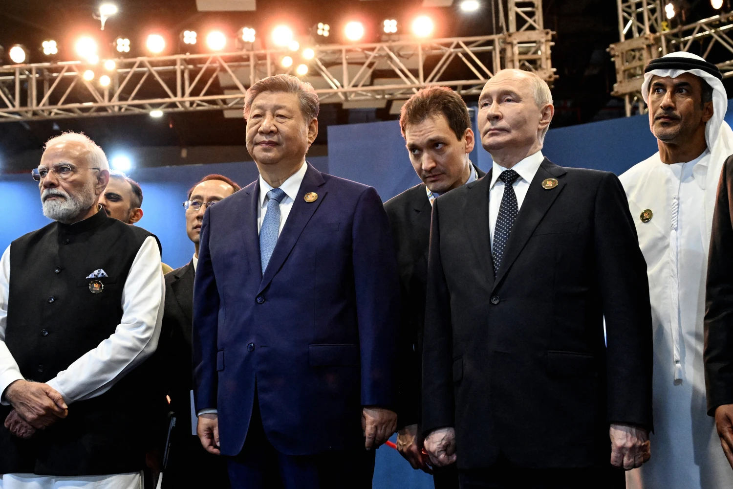 India's Prime Minister Narendra Modi stands alongside China's President Xi Jinping and Russia's President Vladimir Putin alongside other leaders during the 18th BRICS Summit in New Delhi on September 12.