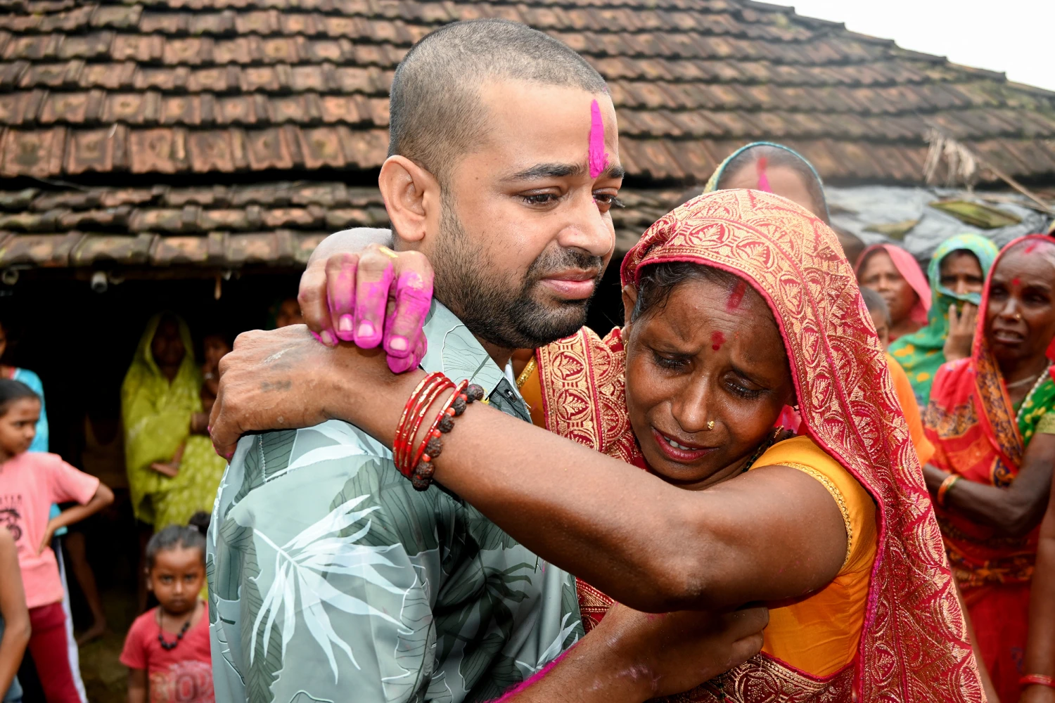 Nepali hydropower worker Sanjay Sah (L) breaks down after meeting his mother at his residence in Nepal's Saptari district on September 13, 2026 after being rescued from a flooded tunnel in the aftermath of deadly flash floods.