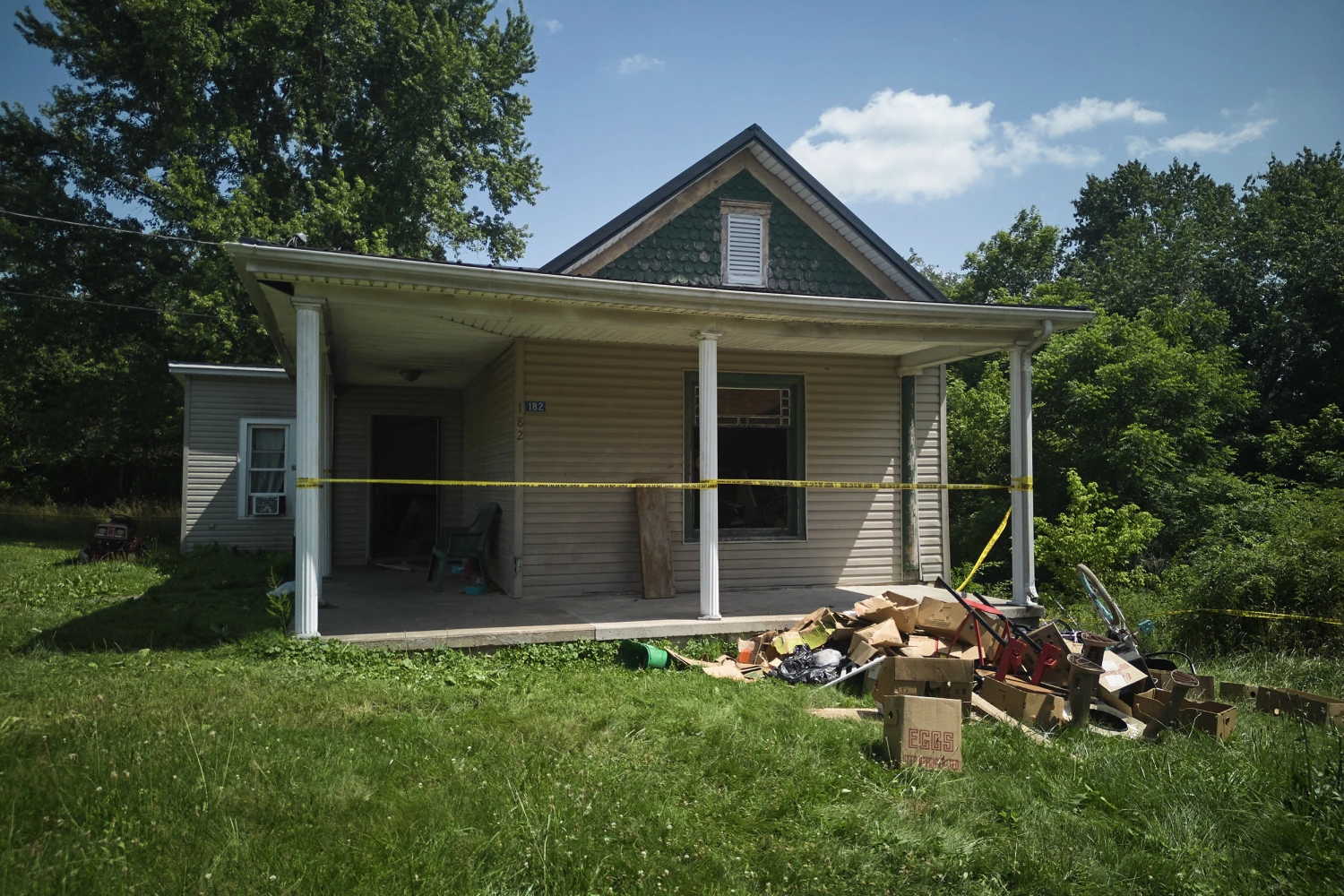 Police tape surrounds a home where authorities say they removed 16 children and arrested four adults in Hamden, Ohio, July 1, 2026.