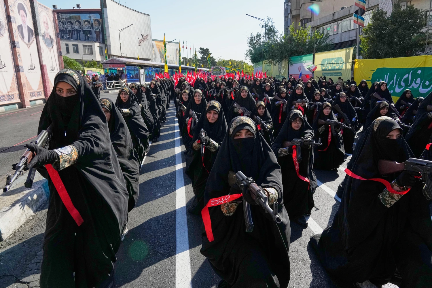 Women affiliated with Iran's Revolutionary Guard carry rifles as they stand during the state-organized "Janfada," or "Sacrifice for Iran," military-style parade in Tehran, Iran, Friday, Sept. 18, 2026.