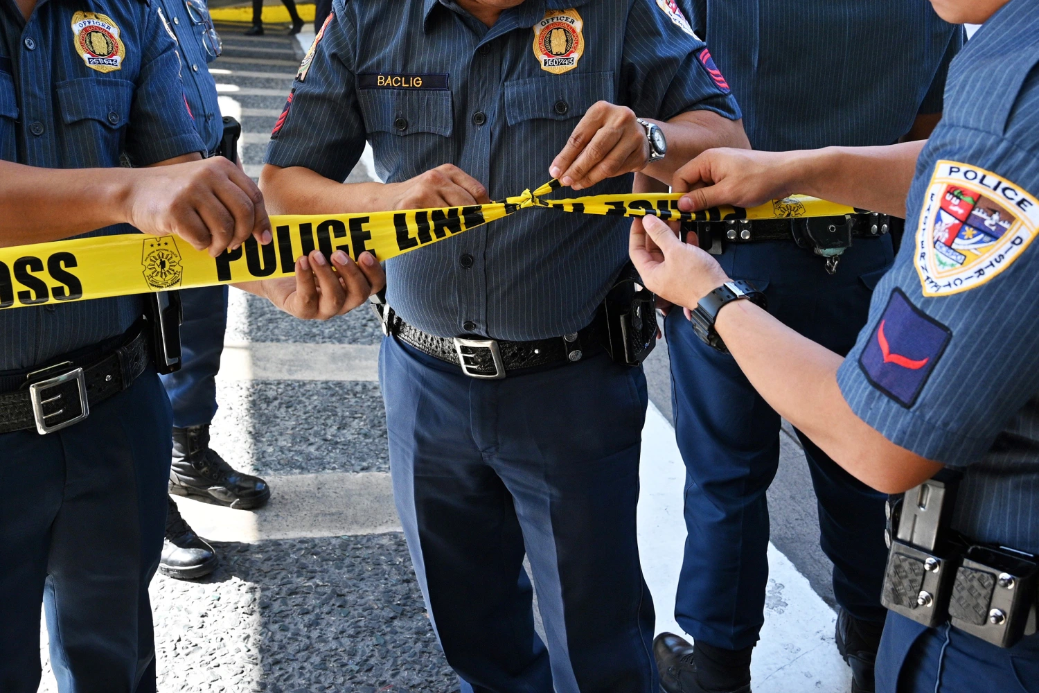 Members of police cordon off the area outside a mall after a hostage situation was reported in suburban Manila on March 2, 2020.