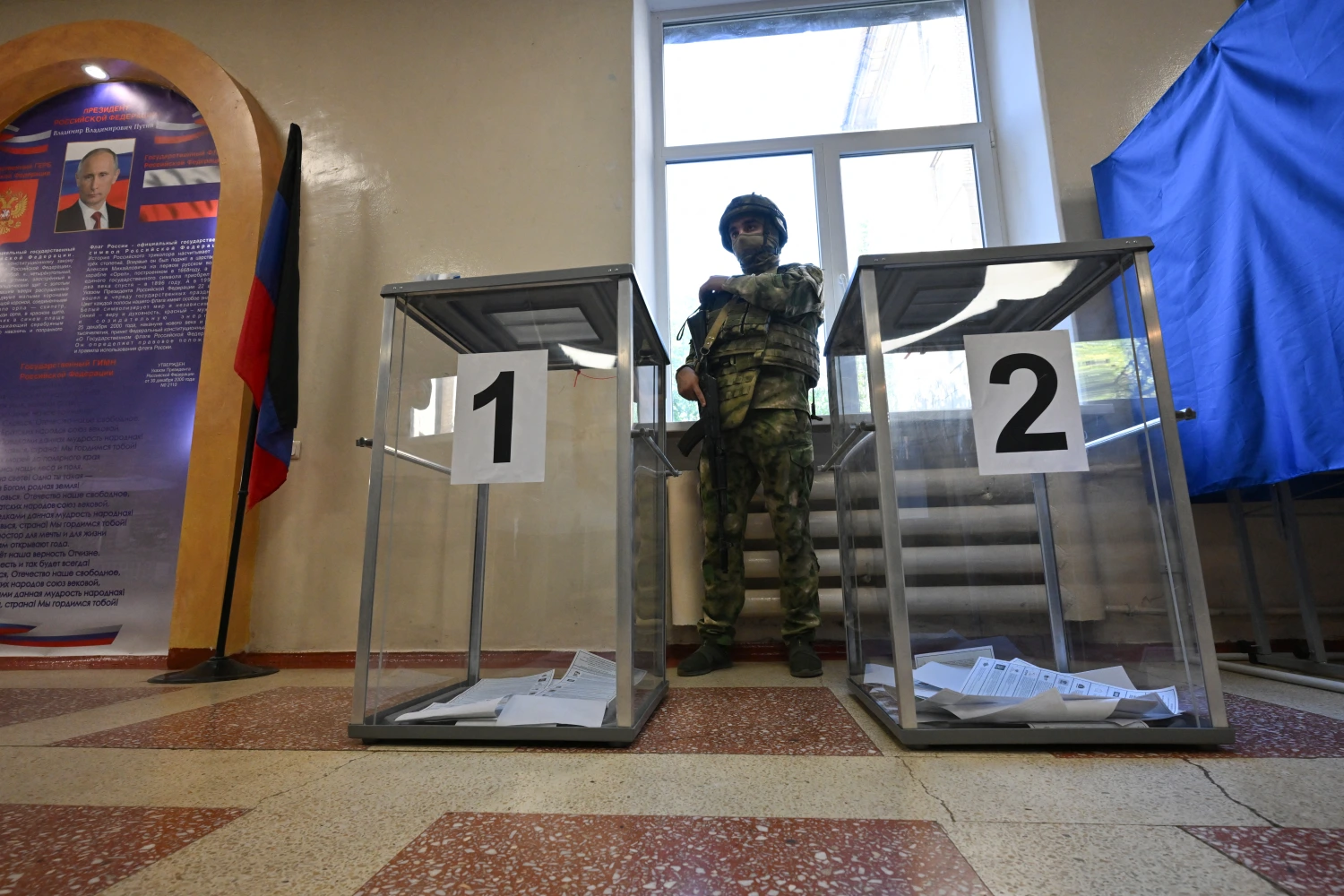 A Russian serviceman stands in a polling station during Russia's parliamentary election in Donetsk, Russian-controlled Ukraine, on September 18.