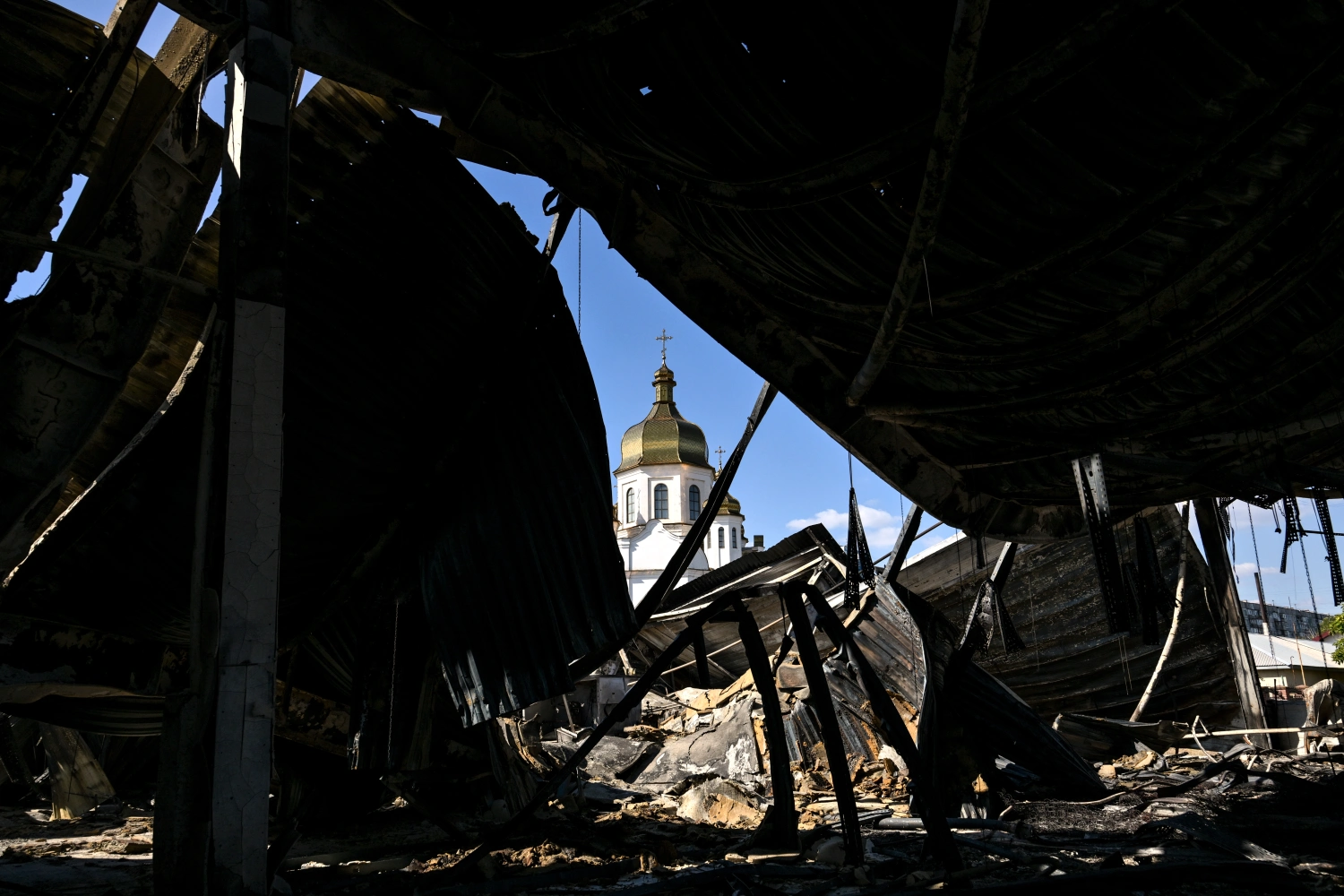 The Church of St Nicholas is pictured from the Amstor shopping centre in Zaporizhzhia, Ukraine, which burned down following a drone attack, on September 18.
