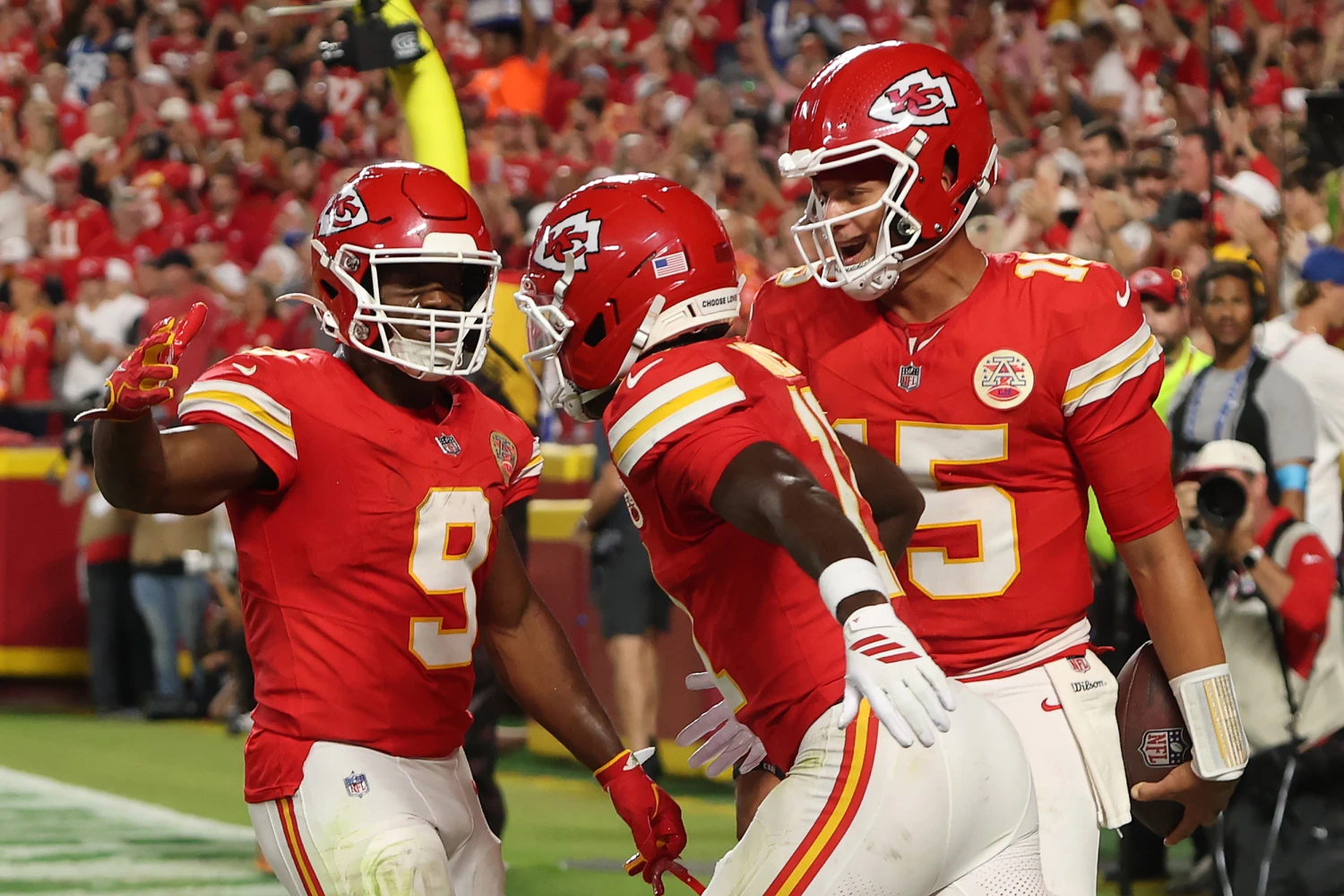 Chiefs' Jalen Royals celebrates a touchdown with Kenneth Walker III and Patrick Mahomes at Arrowhead Stadium.