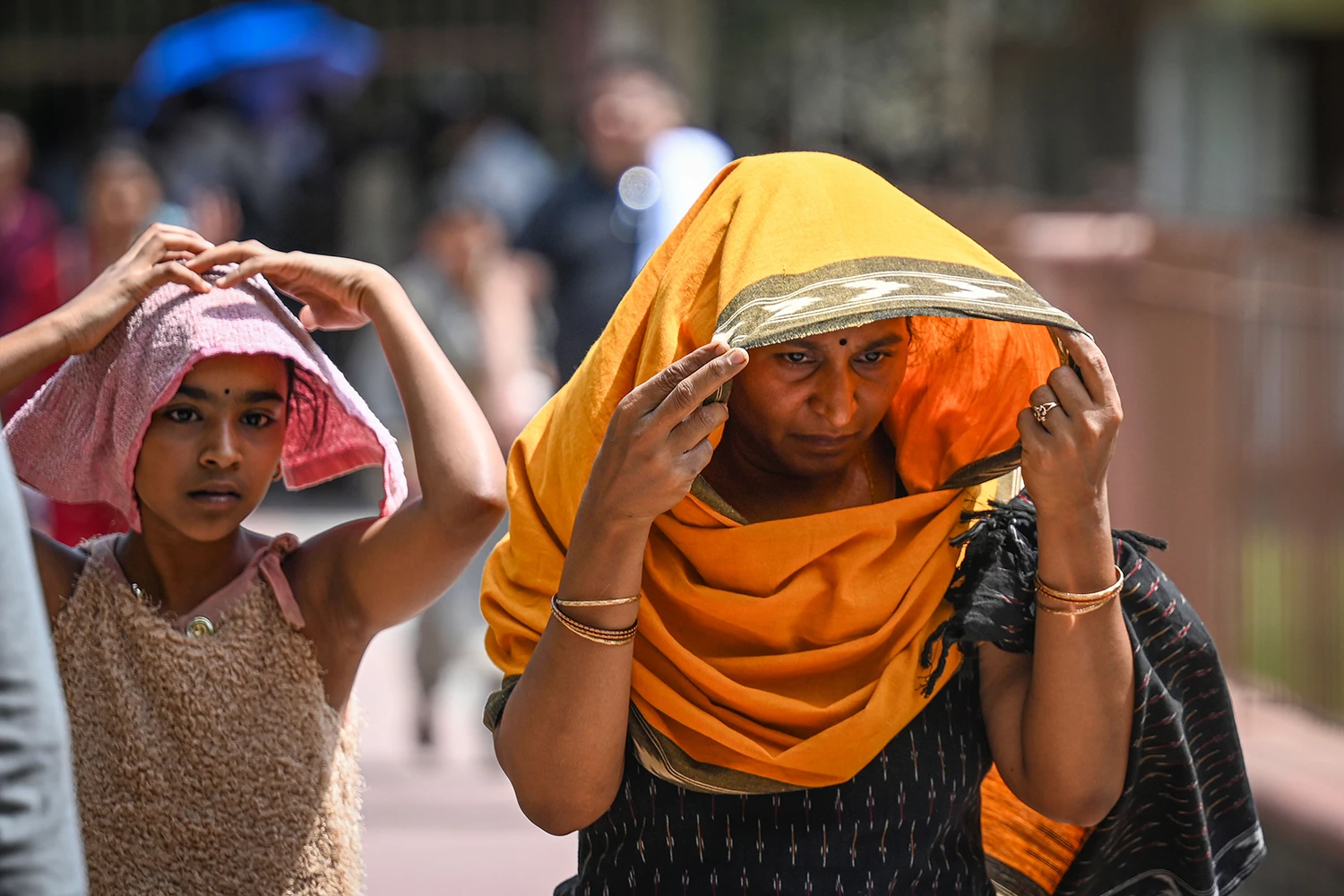 Women shield themselves from excessive heat in New Delhi on June 9, 2026.