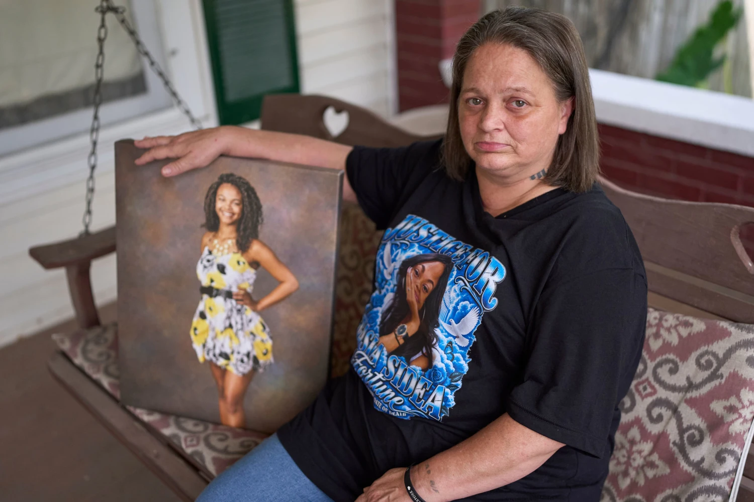 Christy Spivey poses with a portrait of her late daughter, Tasia Fortune, in Marion, Ky.
