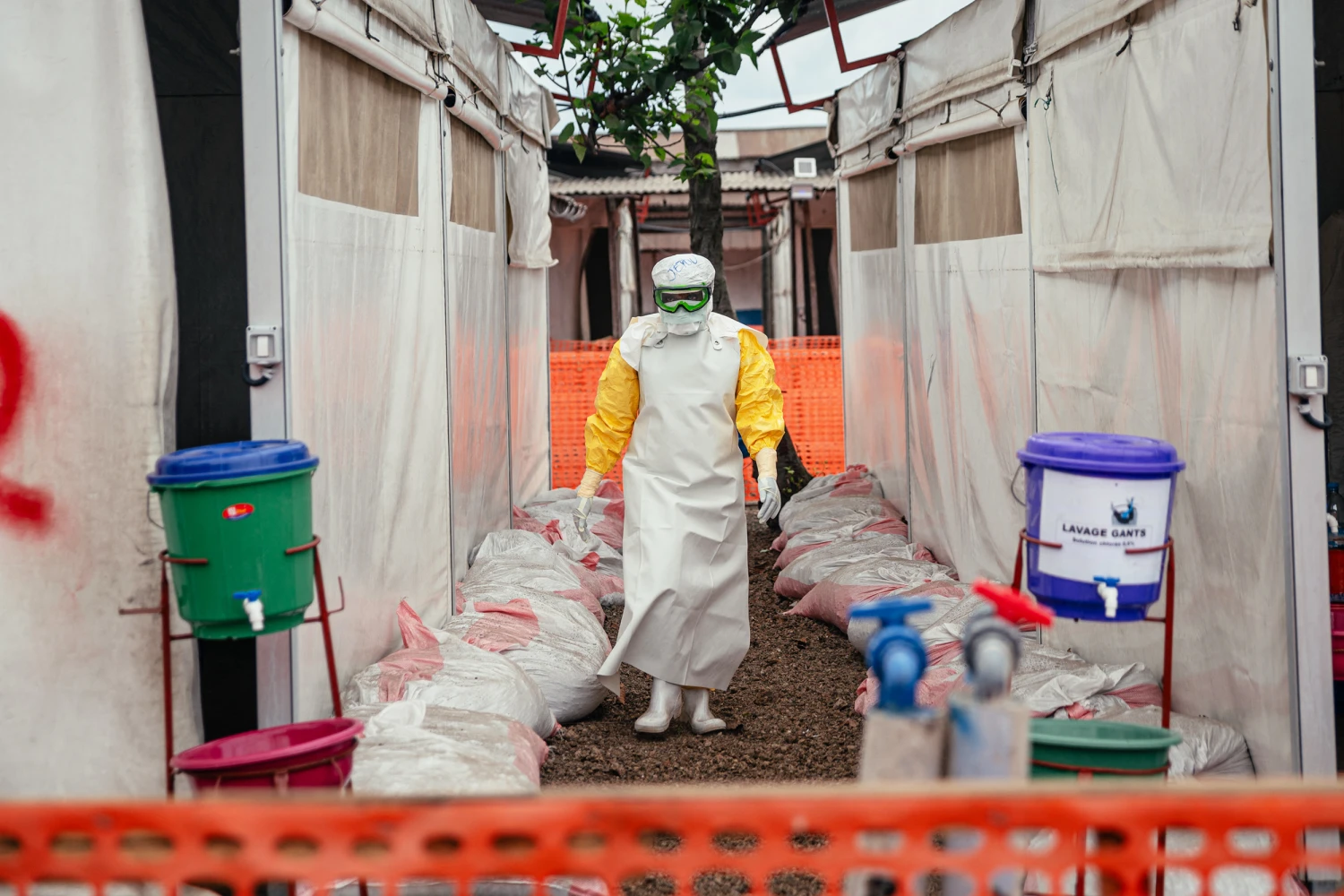 A Doctors Without Borders (MSF) doctor wearing personal protective equipment moves through the isolated red zone to monitor patients, provide medical care, and ensure sanitation of the facility at the Ebola Treatment Center (ETC) in Munigi on June 2, 2026.