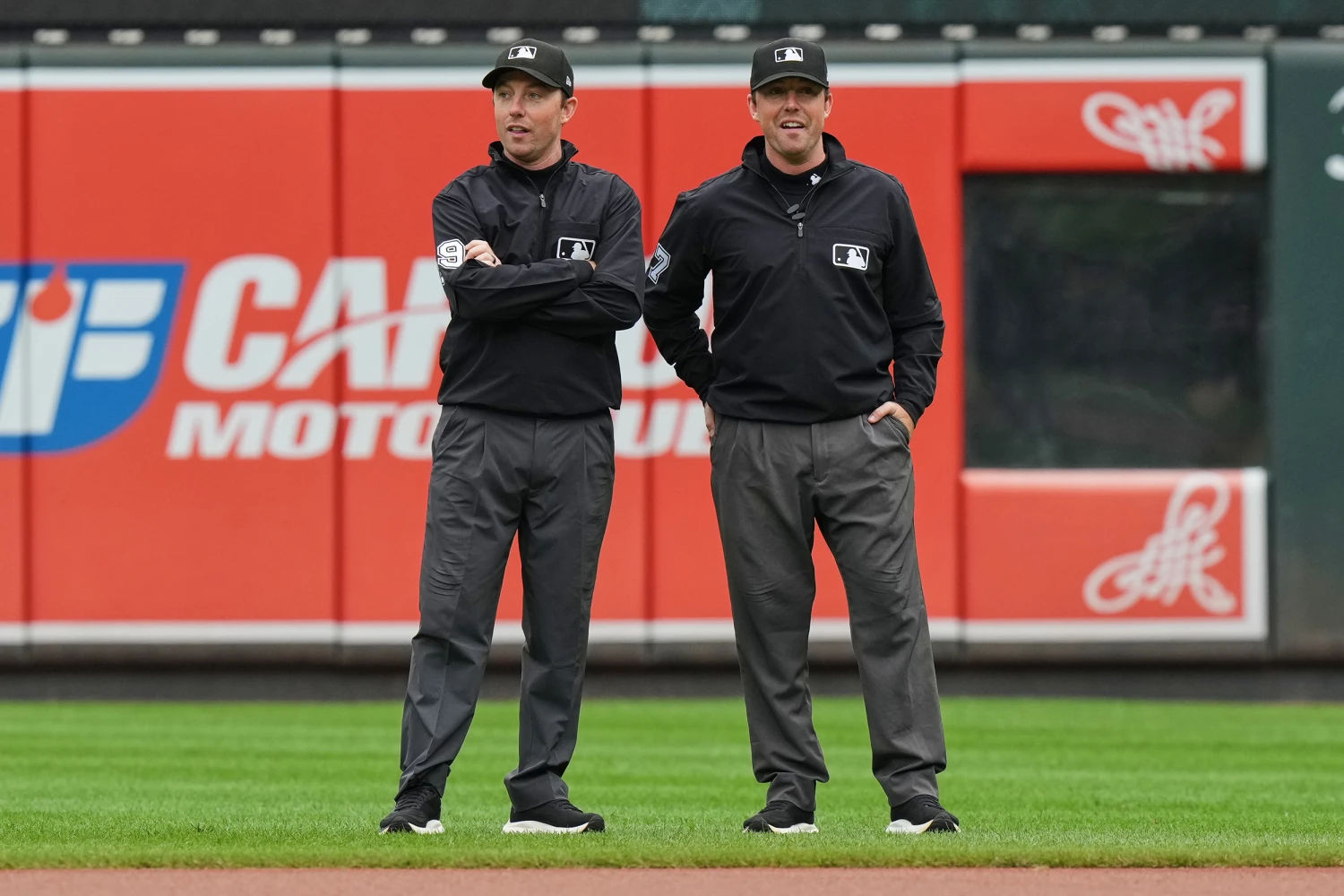 Second base umpire Tyler Jones, left, and his twin brother first base umpire Austin Jones talk before the first baseball game of a doubleheader between the Baltimore Orioles and the Toronto Blue Jays, Wednesday, Sept. 23, 2026, in Baltimore.